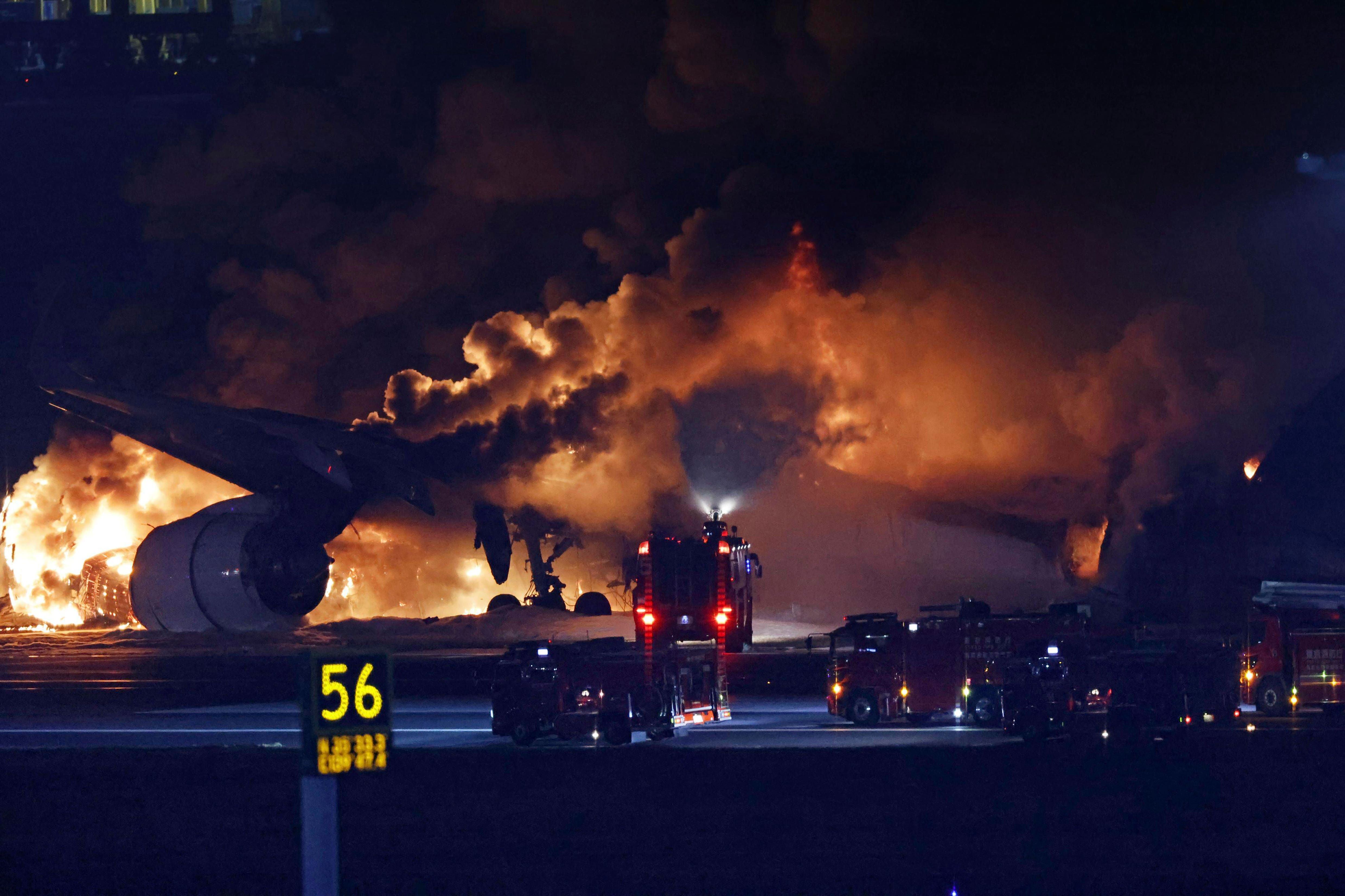 A Japan Airlines plane on fire on the runway of Haneda airport on Tuesday (Kyodo News via AP)