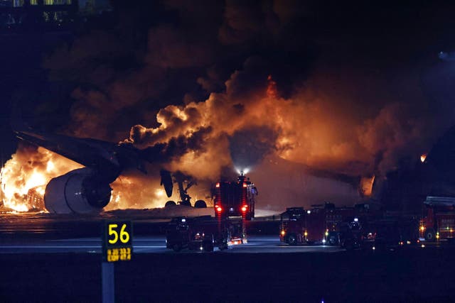 A Japan Airlines plane on fire on the runway of Haneda airport on Tuesday (Kyodo News via AP)