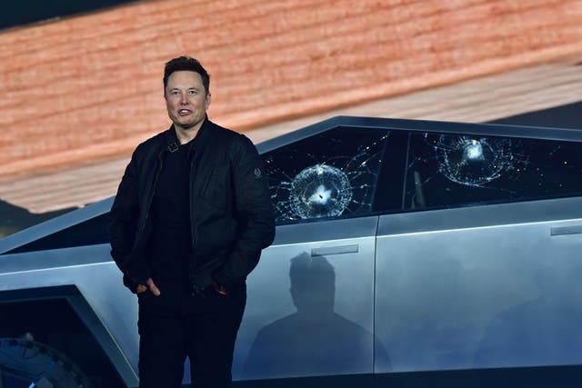 <p>Tesla co-founder and CEO Elon Musk stands in front of the shattered windows of the newly unveiled all-electric battery-powered Tesla’s Cybertruck at Tesla Design Center in Hawthorne, California on November 21, 2019</p>