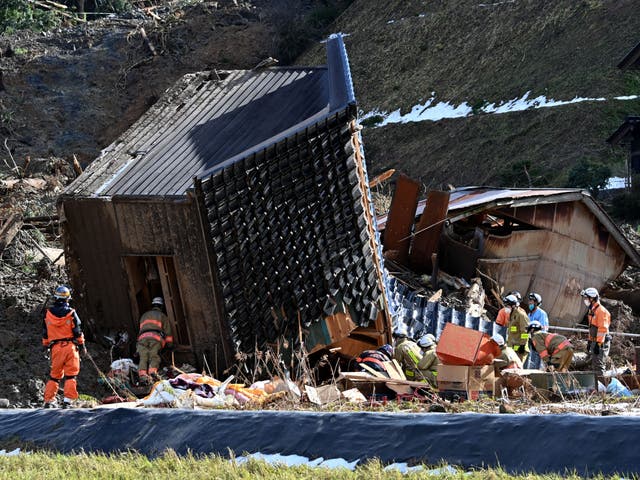 <p>Firefighters search for missing people at the site of a collapsed house in the city of Wajima, Ishikawa prefecture</p>