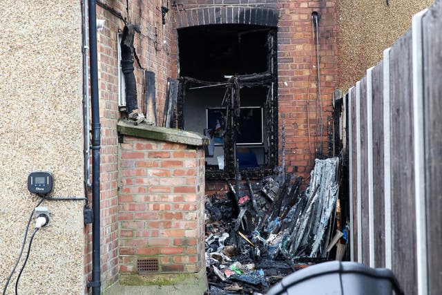 <p>Burnt out window at the rear of Conservative MP Mike Freer’s office </p>