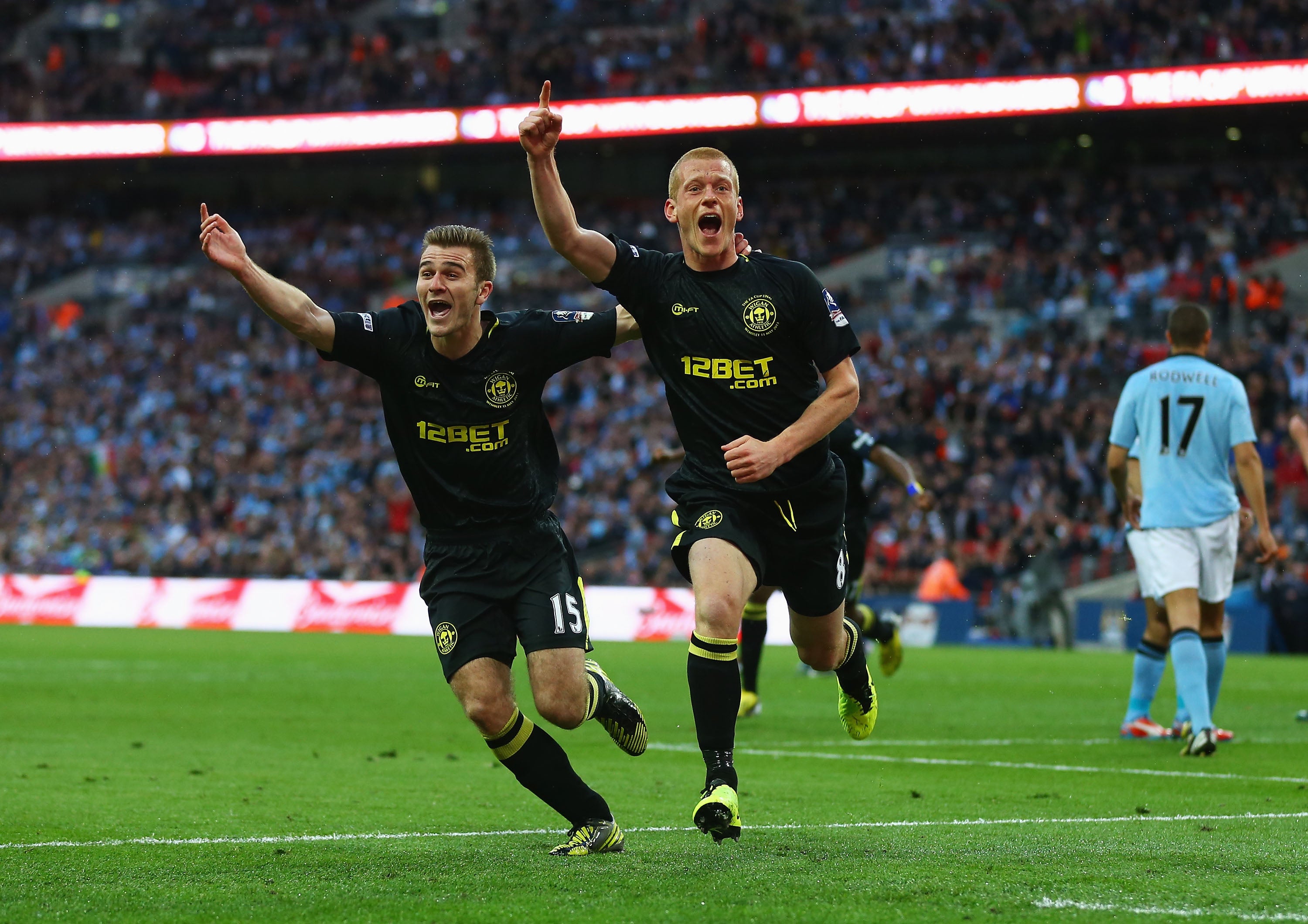 McManaman celebrates with Ben Watson, who scored the winning goal in Wigan’s 1-0 win at Wembley