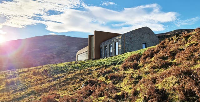 <p>The main building is perched on a hilltop with soaring sea views across to the neighbouring Isle of Raasay</p>