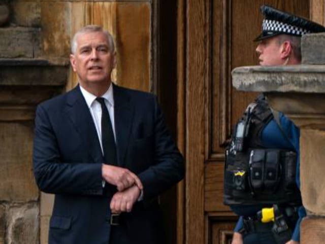 <p>A police officer stands alongside Britain's Prince Andrew, Duke of York as they await the arrival of the coffin of Queen Elizabeth II</p>