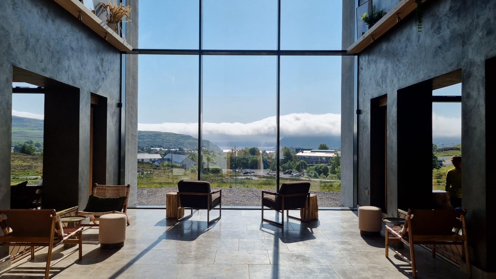 The lobby’s floor-to-ceiling windows perfectly frame Loch Portree and the Sound of Raasay