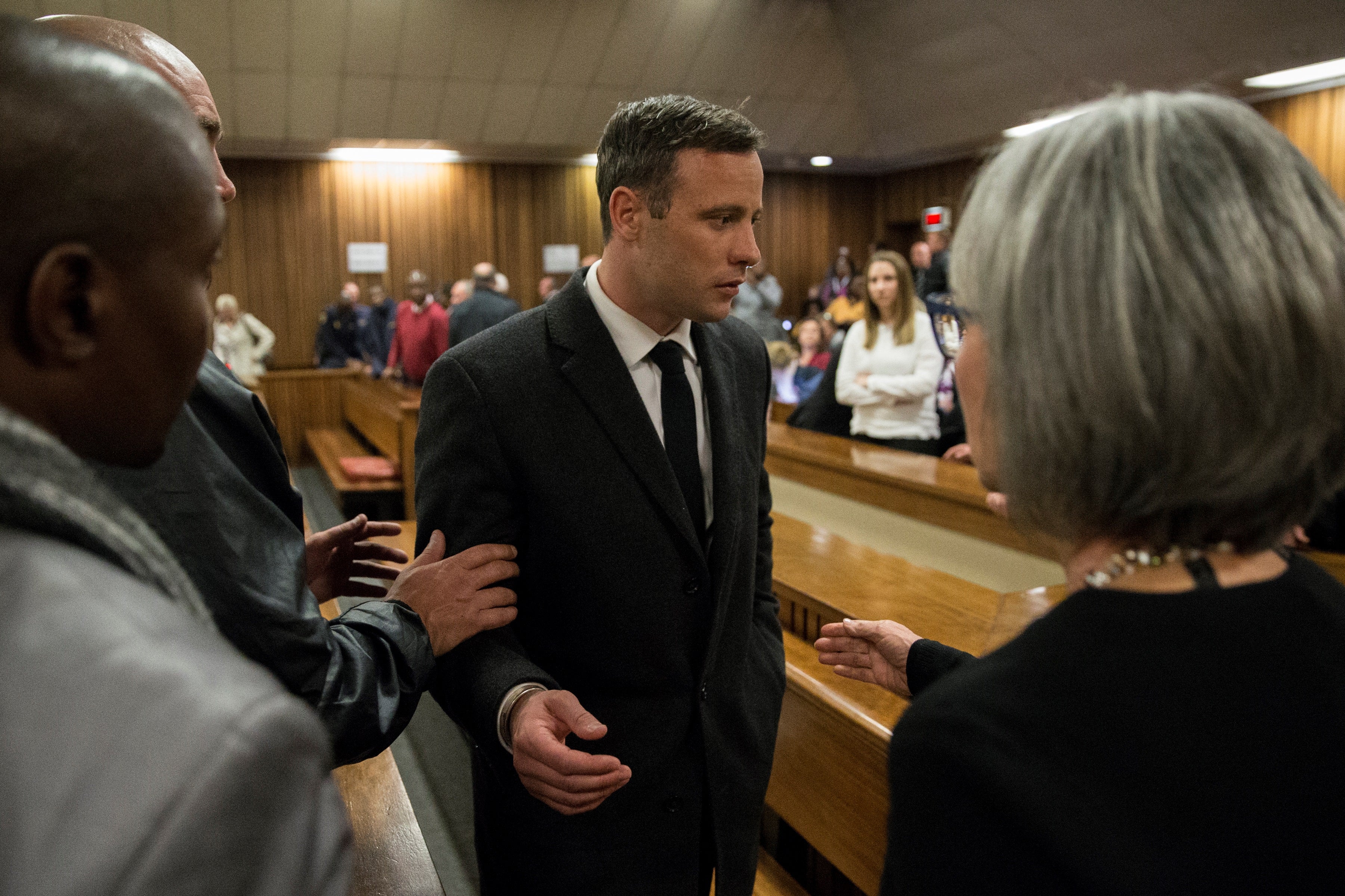 Olympic athlete Oscar Pistorius speaks with relatives after sentencing at the High Court on 6 July 2016 at the High Court in Pretoria, South Africa