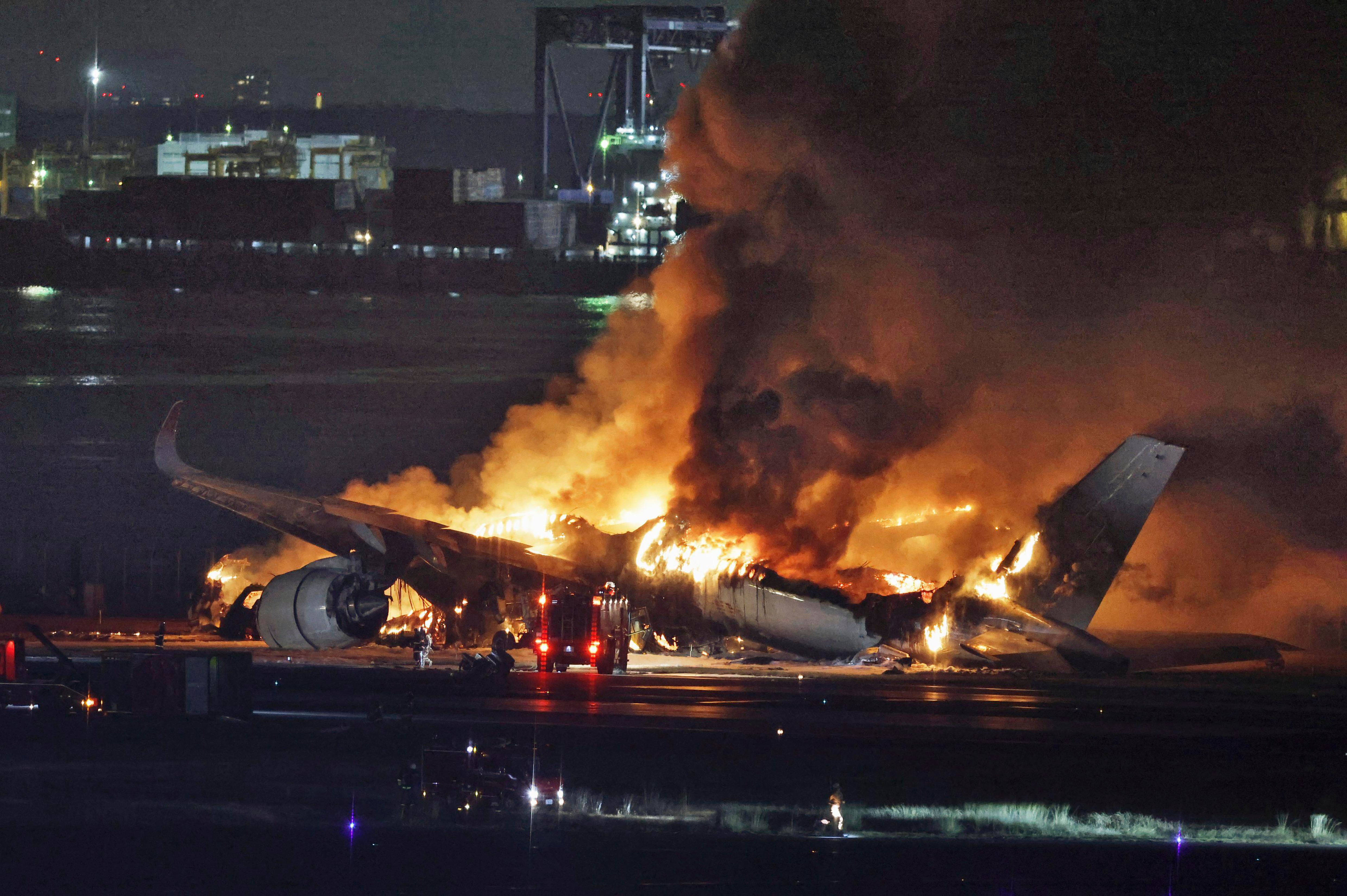 The Japan Airlines Airbus A350 in flames at Tokyo’s main airport, Haneda, after striking a Dash-8 propeller plane that had strayed onto the runway