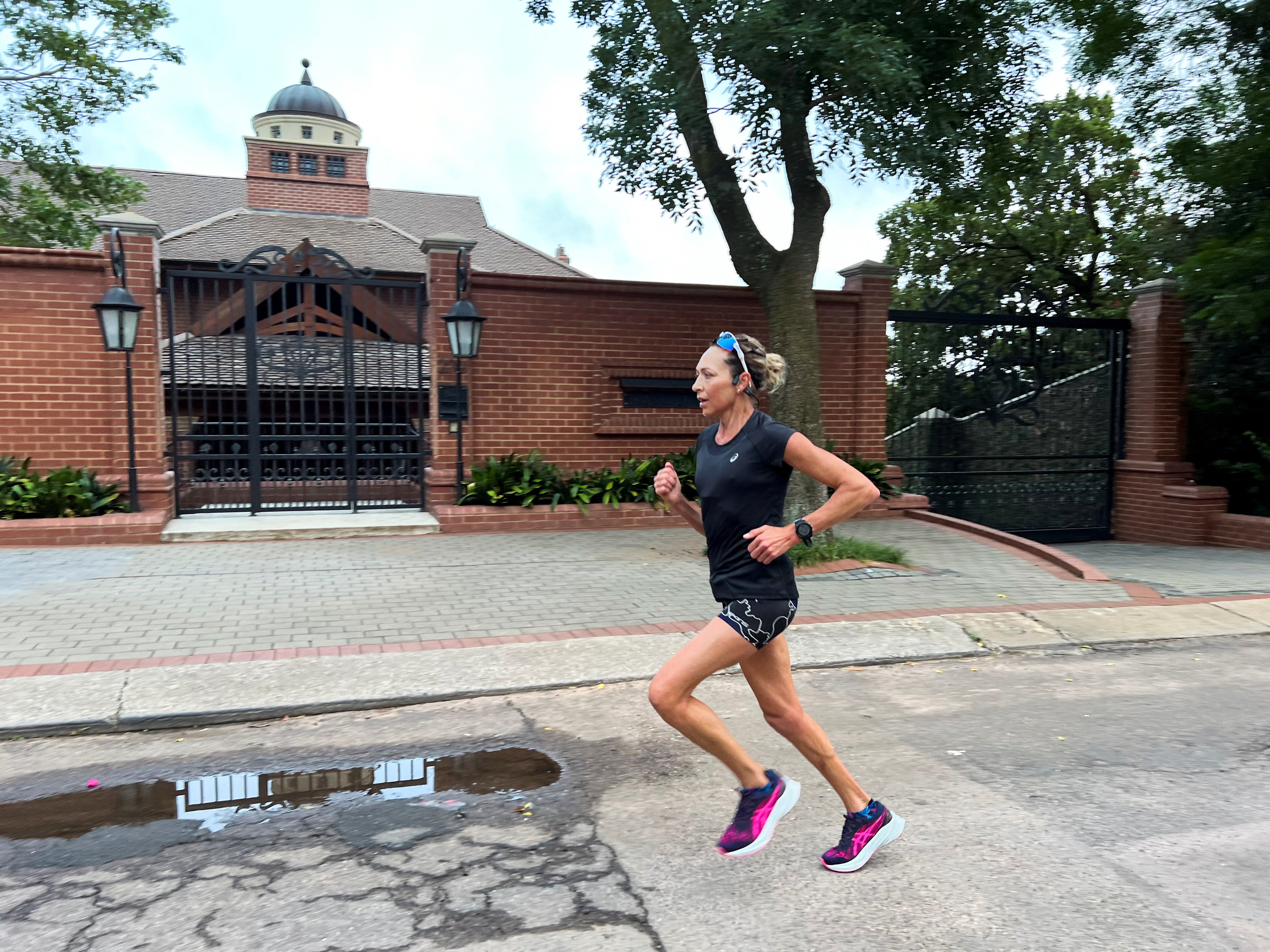 A woman jogs past the house of Oscar Pistorius' uncle Arnold, ahead of Oscar Pistorius' expected release from prison, in Pretoria, South Africa