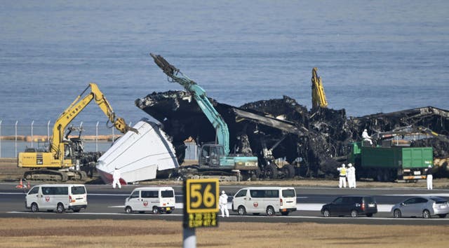 <p>A removal work is underway at the site of a planes collision at Haneda airport in Tokyo</p>