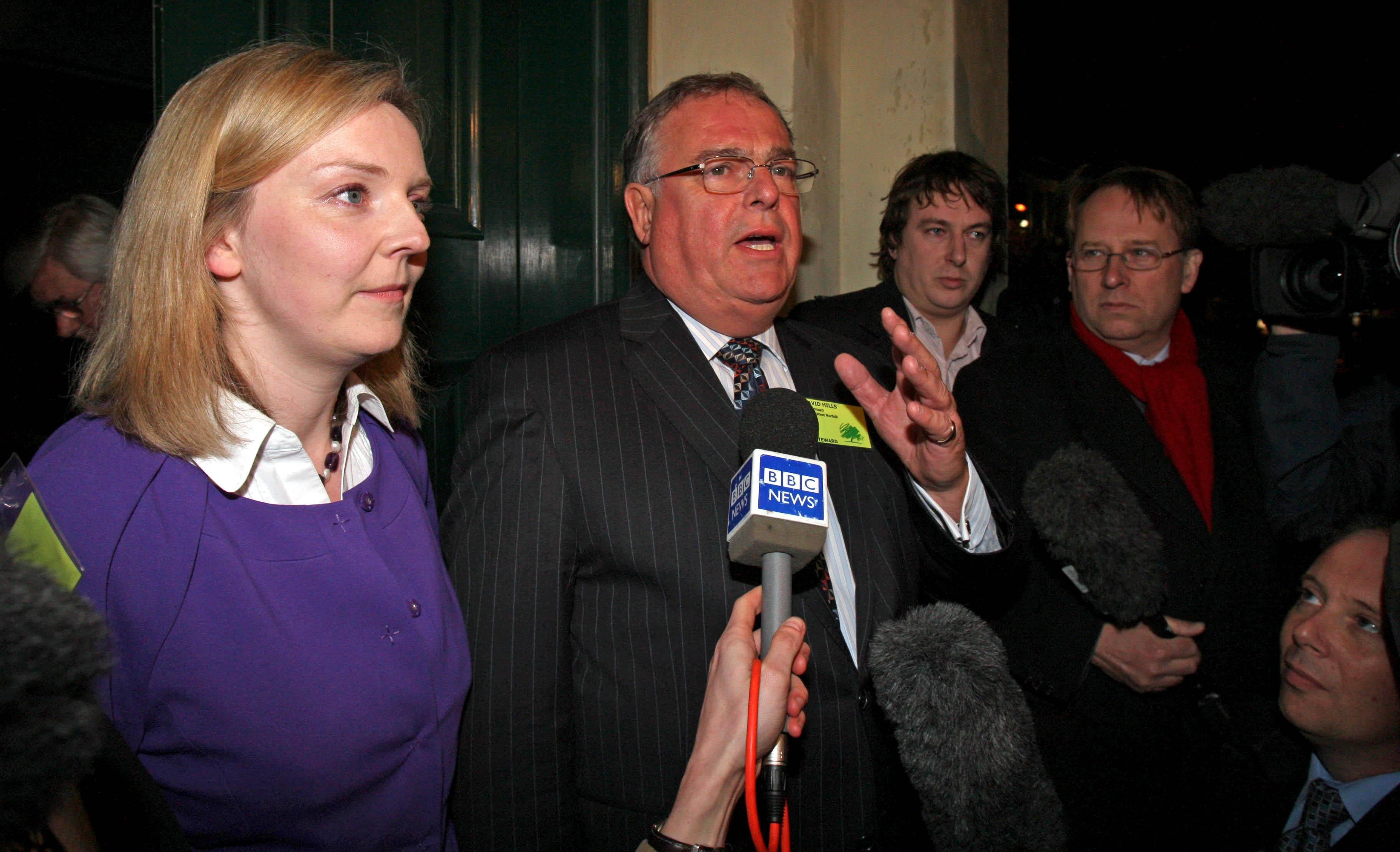 Conservative Party chair for South West Norfolk David Hills speaking to the media alongside Truss during her 2009 battle against deselection