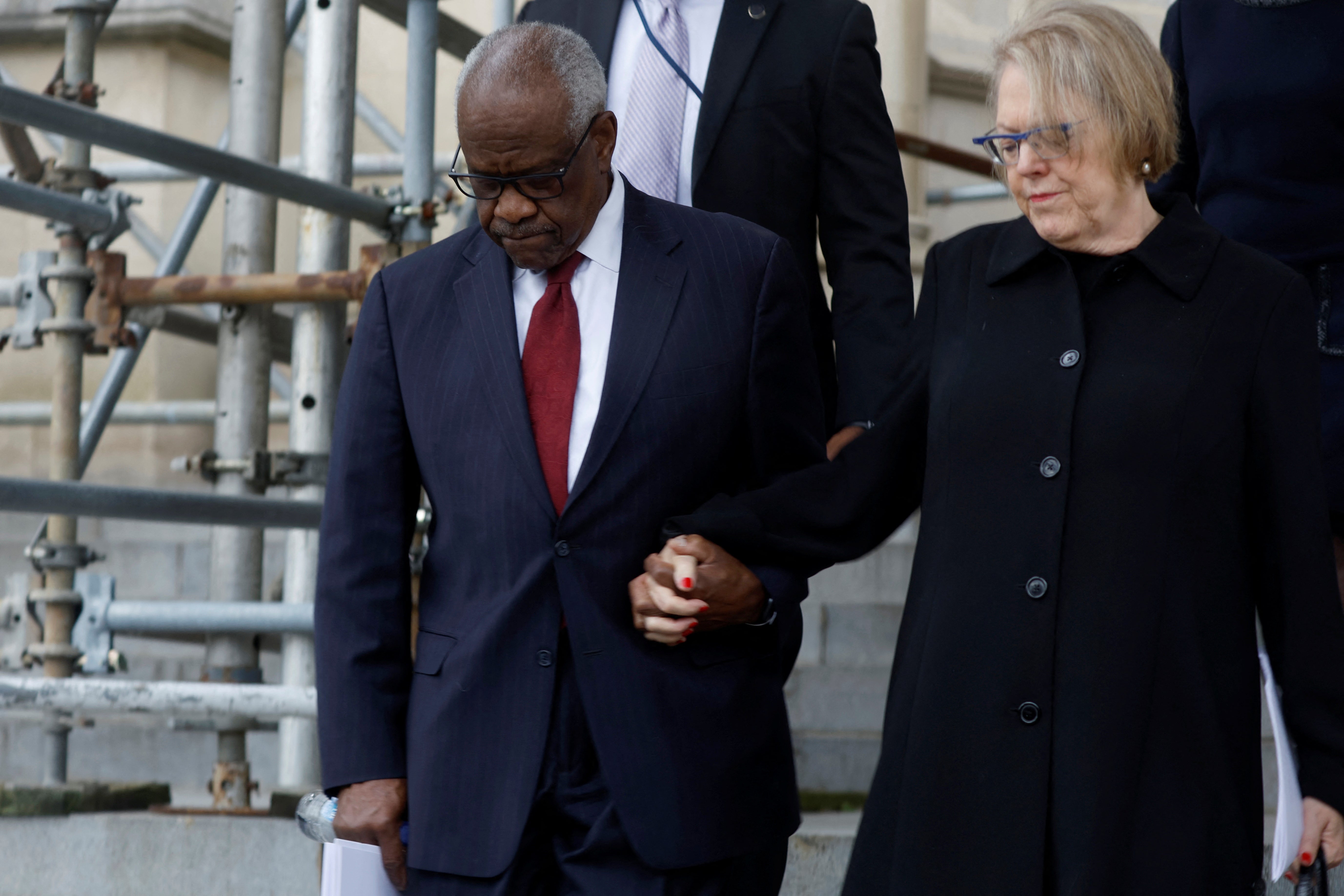 House Democrats have urged Supreme Court Justice Clarence Thomas, left, to recuse himself from a case involving Donald Trump’蝉 ballot eligiblity, citing his wife, Ginni Thomas, right, who promoted false election claims.