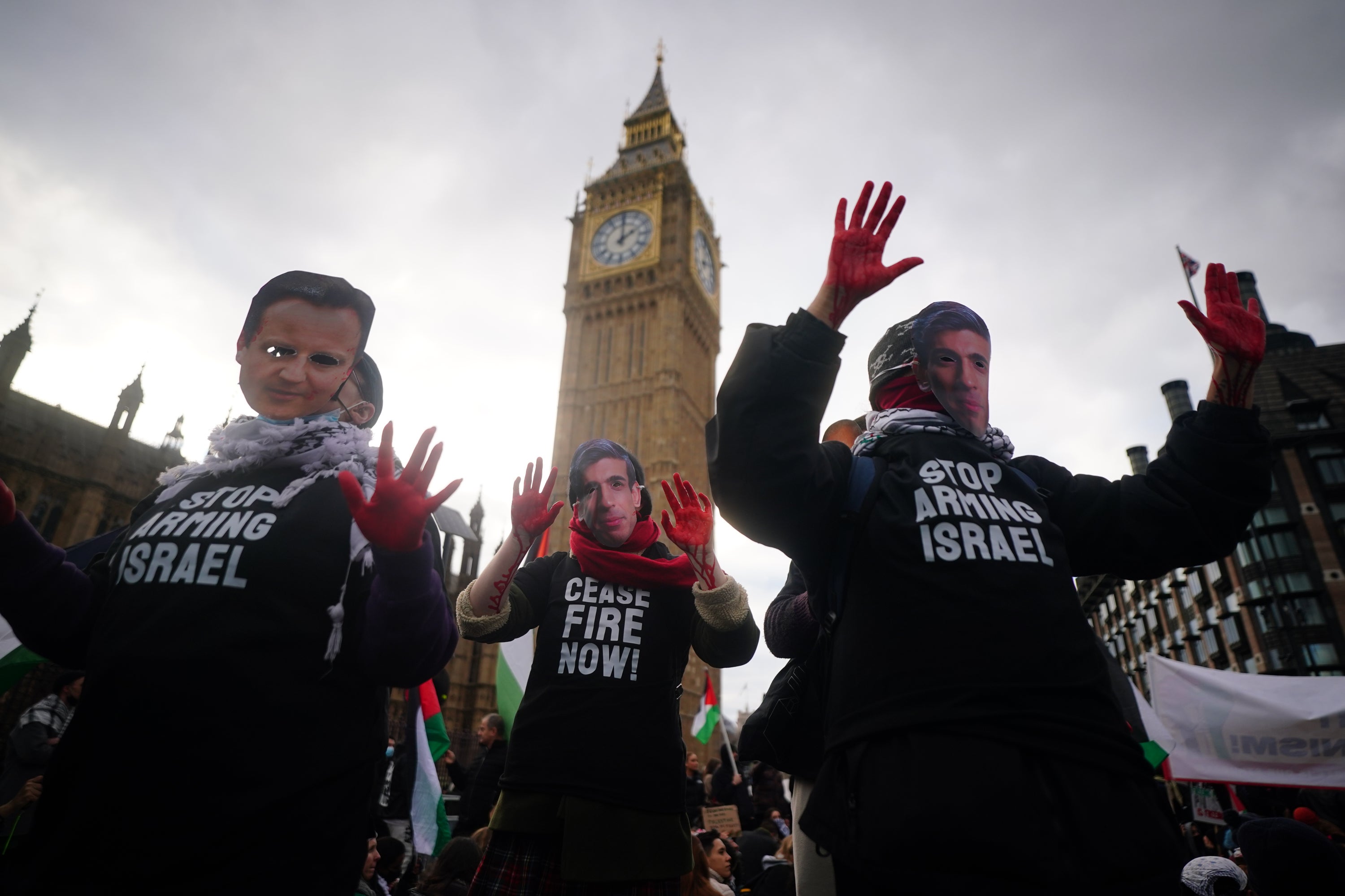 Protesters painted their hands red and wore masks with the faces of politicians