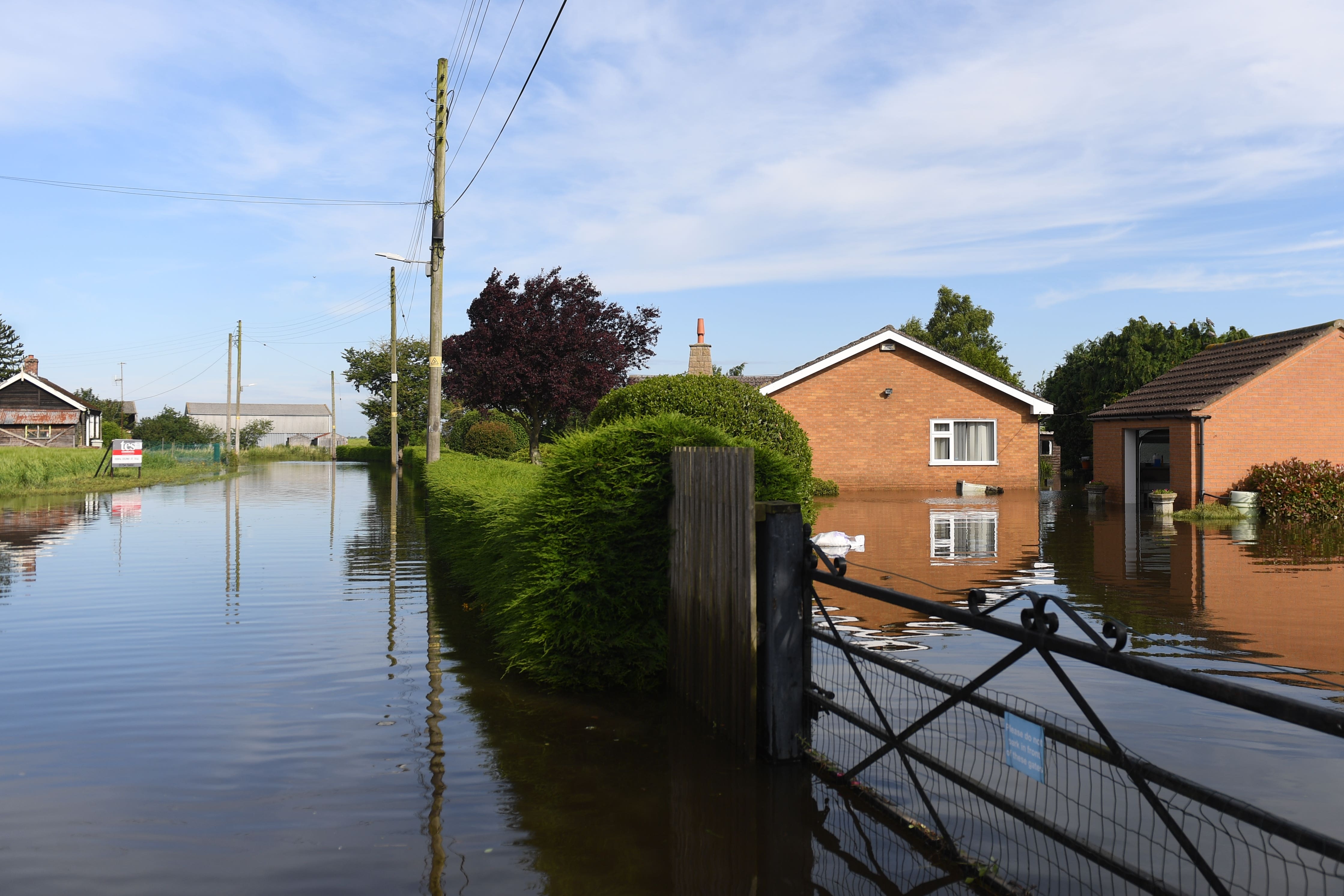 Houses surrounded by flood water on Matt Pit Lane in Wainfleet All Saints in Lincolnshire after the town had to deal with more than two months of rain in just two days