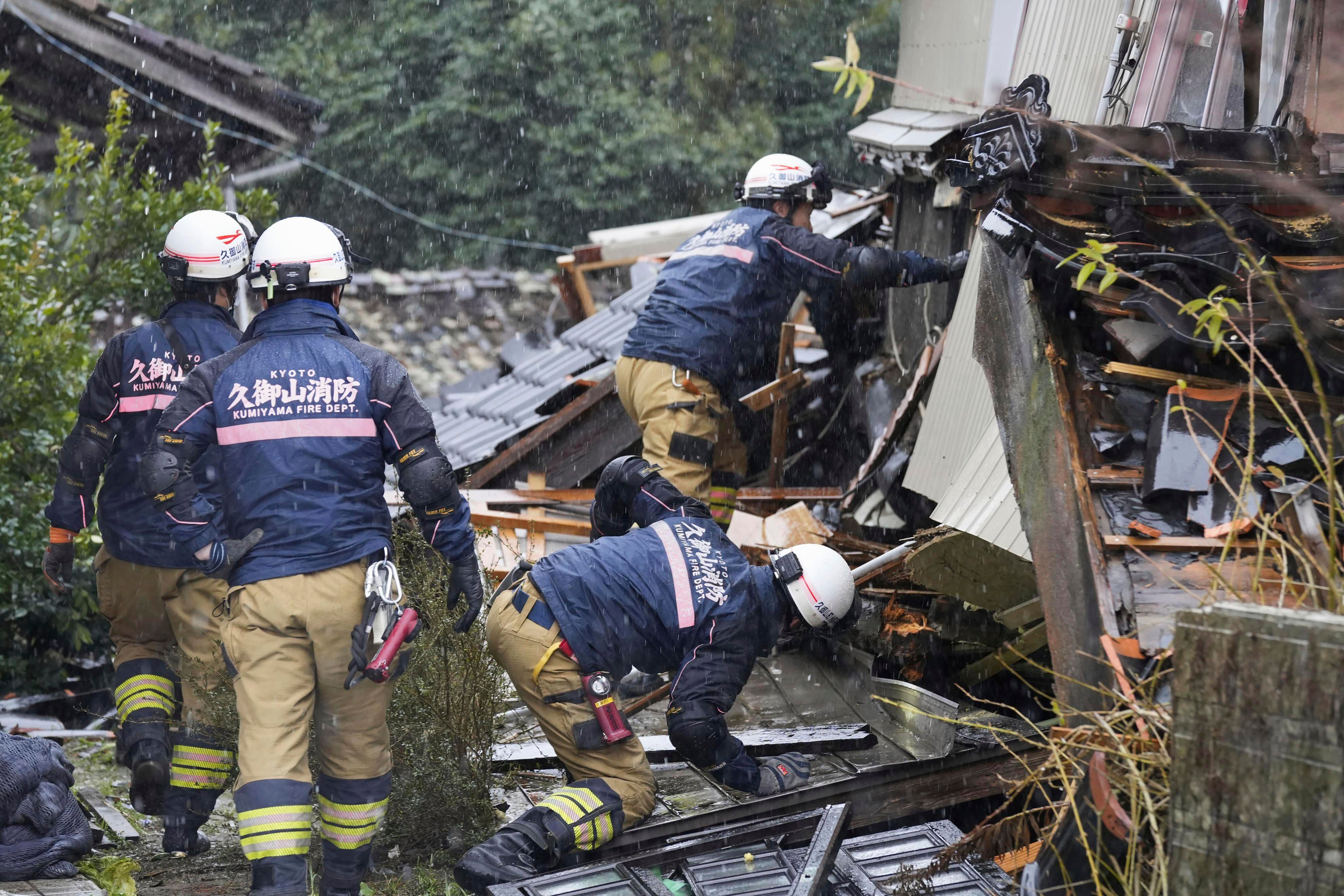 Firefighters conduct a search operation in Suzu, Ishikawa prefecture, Japan on Sunday