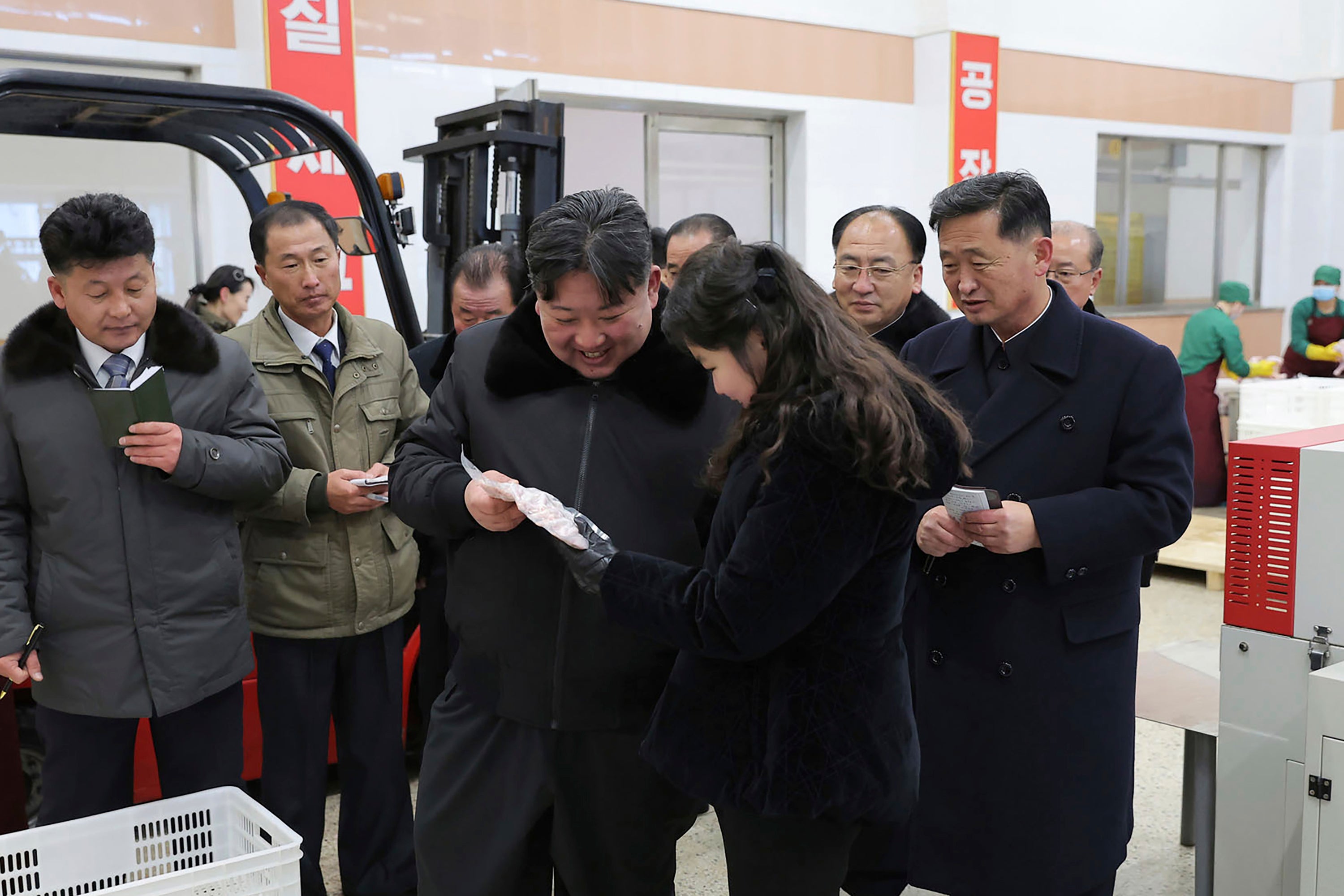 In this photo provided on Monday, 8 January 2024, by the North Korean government, North Korean leader Kim Jong-un, centre, with his daughter visits a newly-built chicken farm in Hwangju County of North Hwanghae Province on 7 January 2024