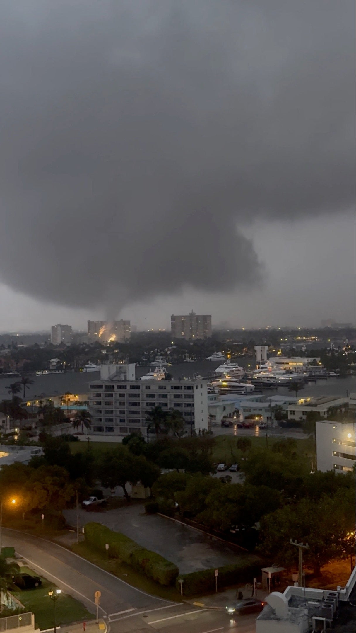 Sparks fly as a tornado touches power cables, in Fort Lauderdale, Florida, U.S