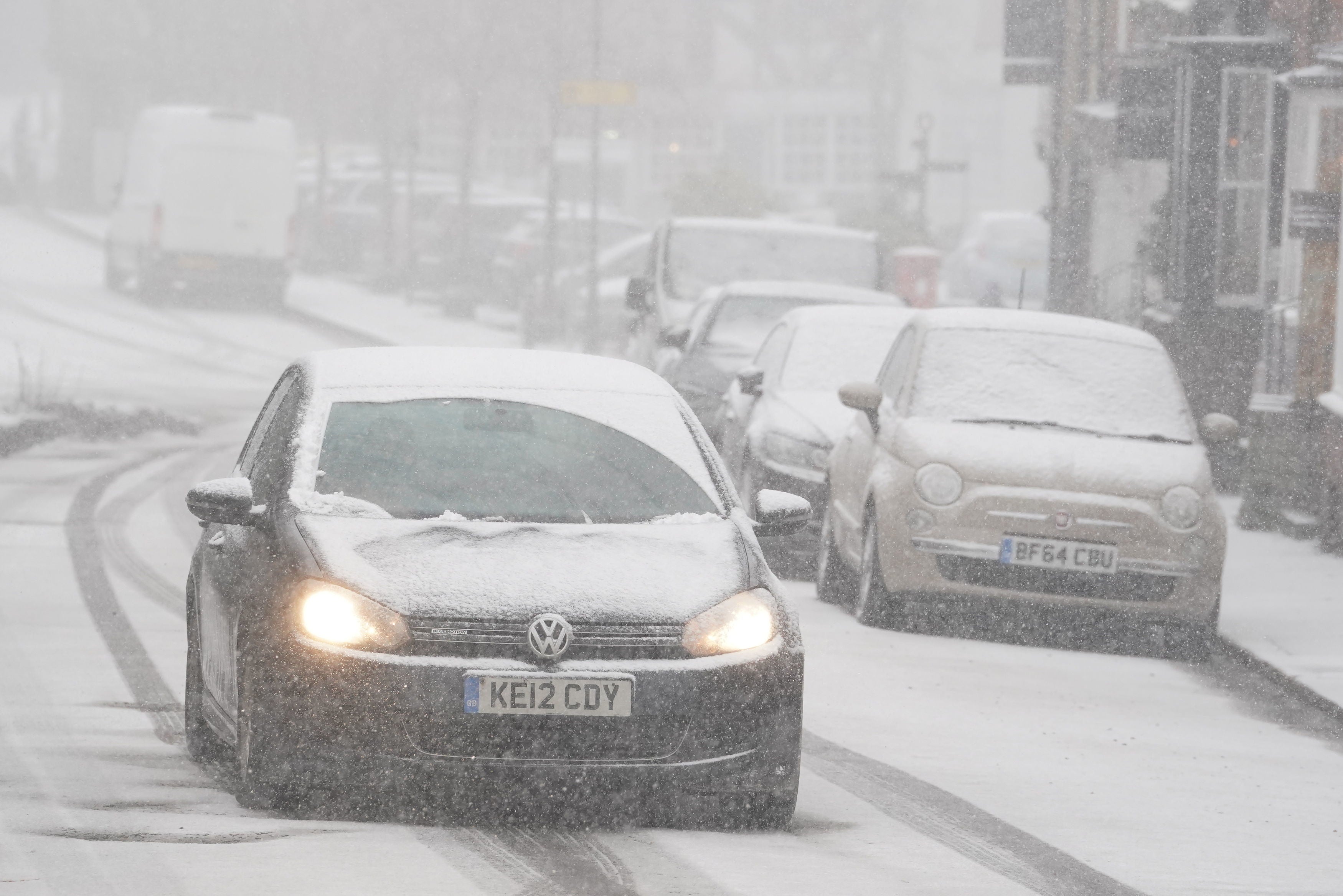 A car driving through a snow flurry in Lenham, Kent. Sleet and snow showers have been forecast for parts of the country on Monday