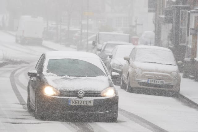 <p>A car driving through a snow flurry in Lenham, Kent. Sleet and snow showers have been forecast for parts of the country on Monday</p>