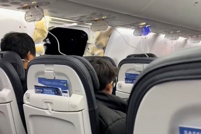 <p>This image from video provided by Elizabeth Le shows passengers near the damage on an Alaska Airlines Boeing 737 Max 9, Flight 1282, which was forced to return to Portland International Airport on Friday, Jan. 5, 2024. (Elizabeth Le via AP)</p>