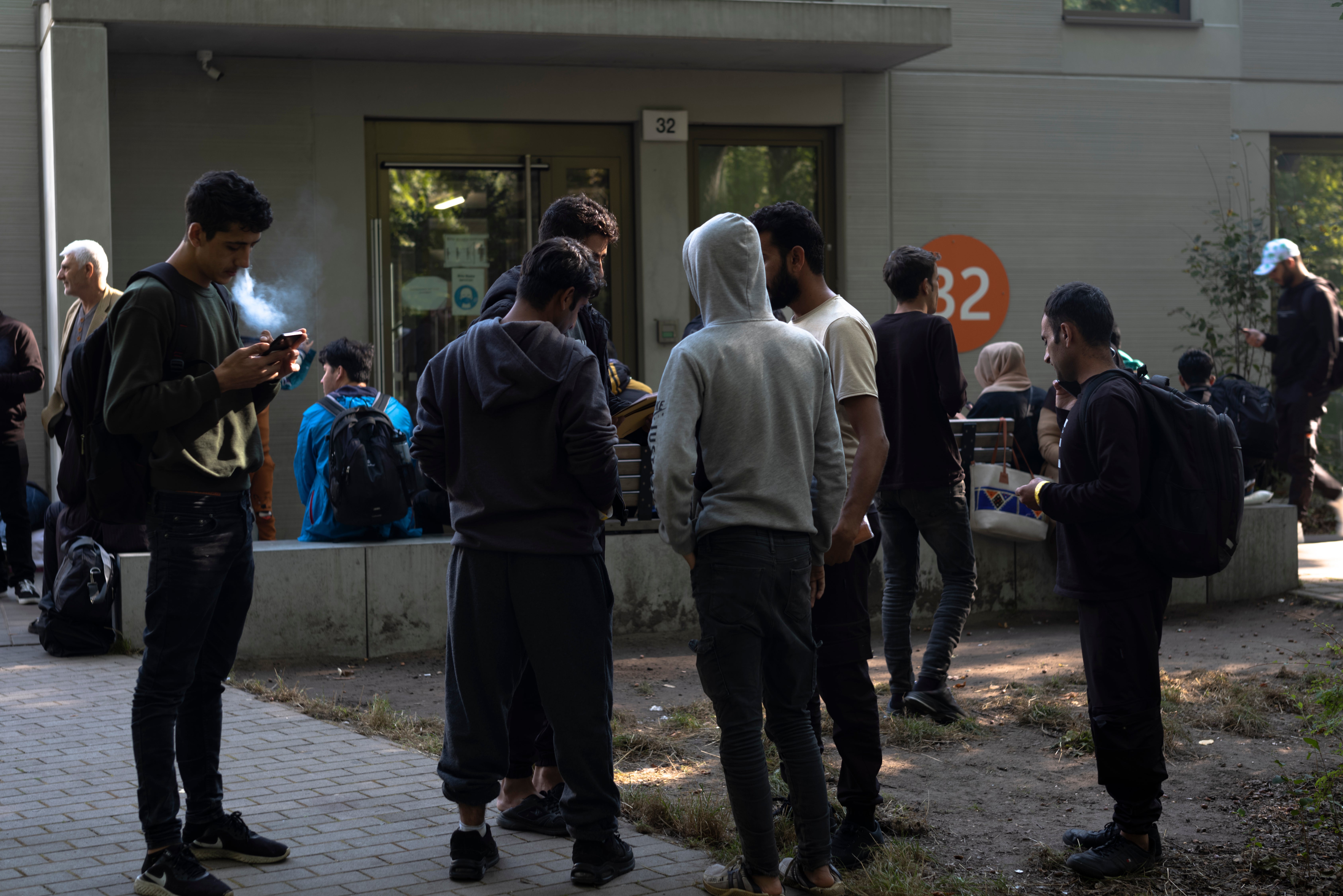 Dozens of people from all over the world line in front of the central registration center for asylum seekers in Berlin