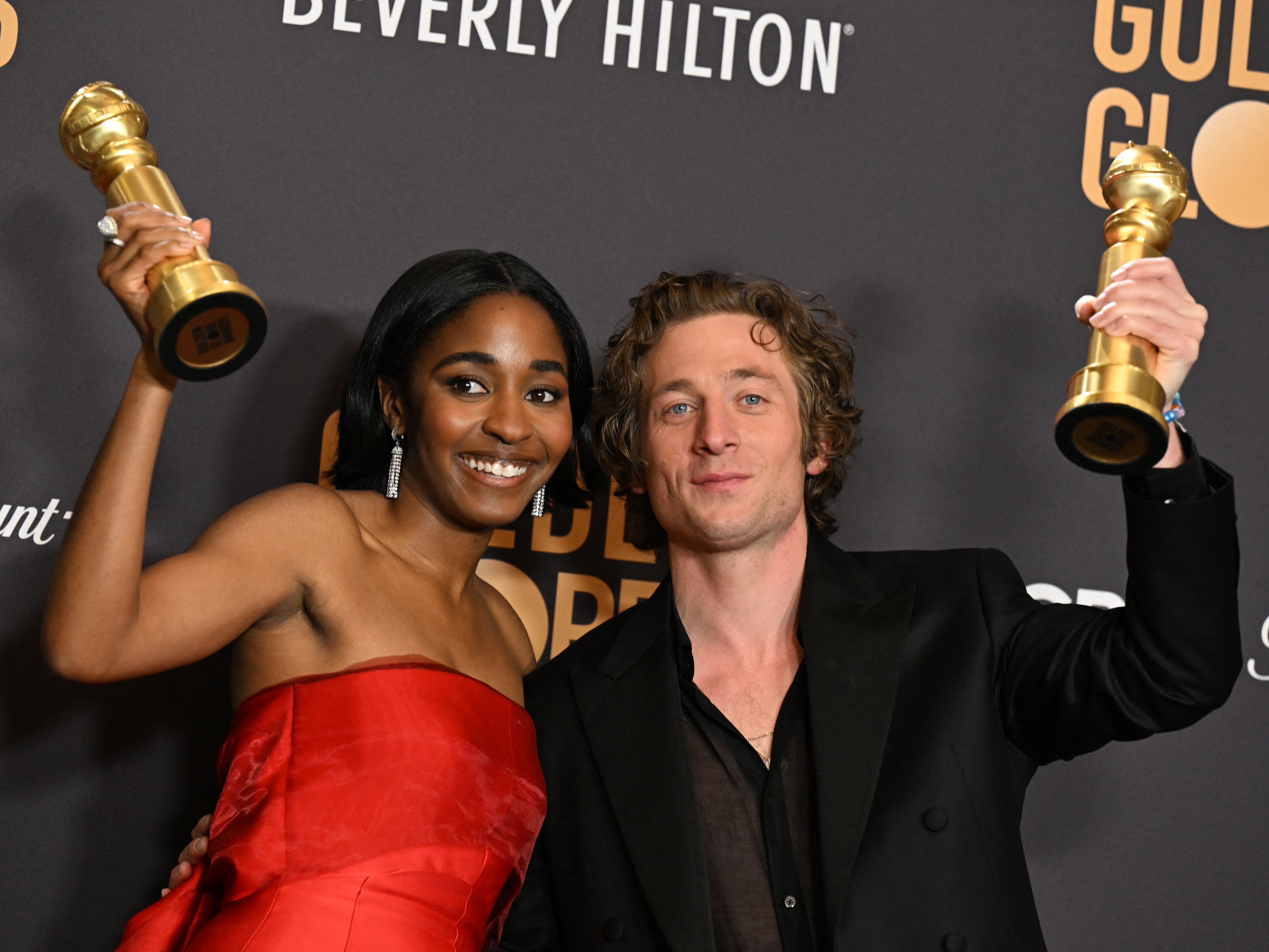 Edebiri and White holding aloft their Golden Globes earlier this month