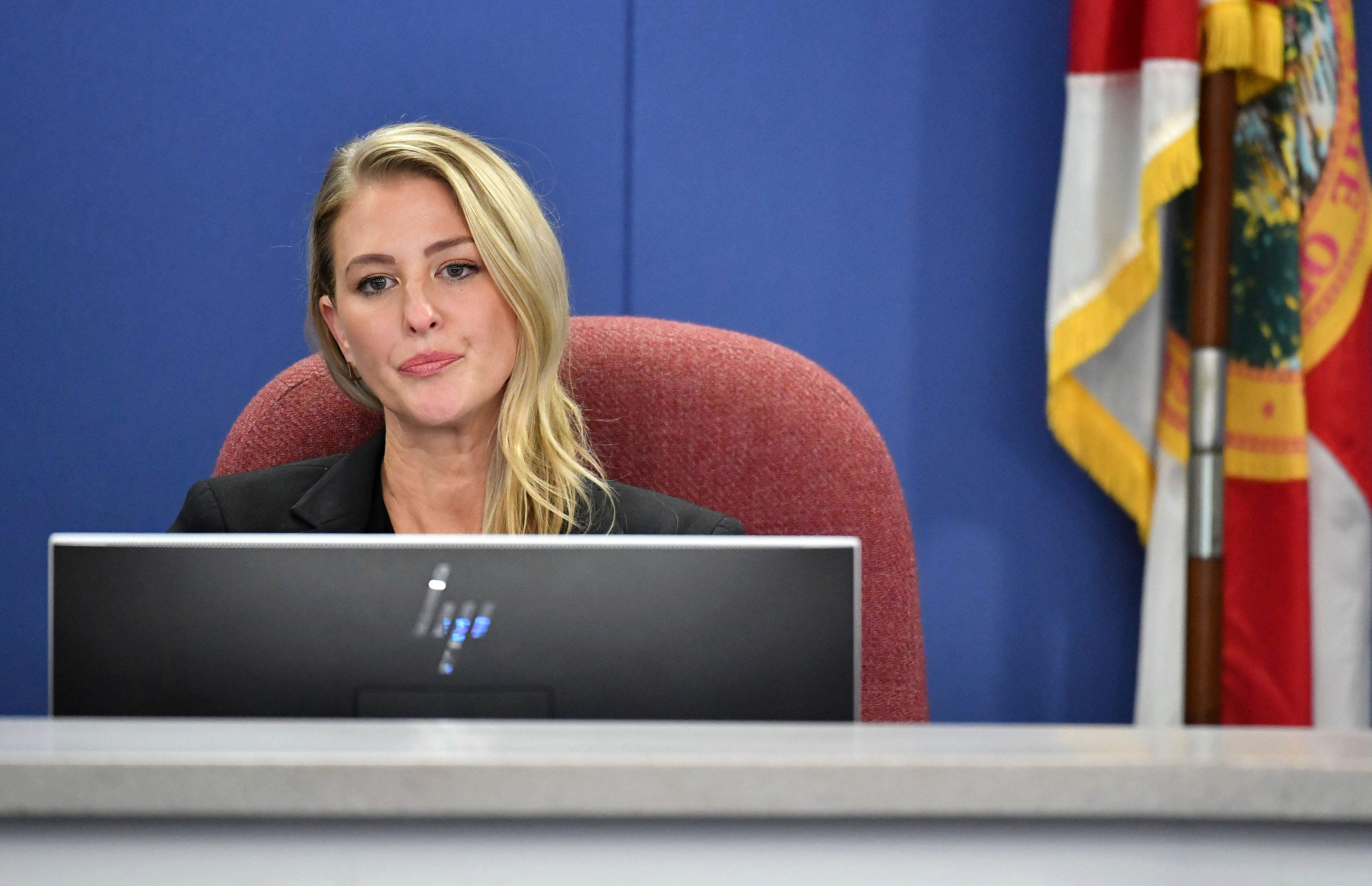 Sarasota County School Board member Bridget Ziegler listens to public comments in December 2023, after her fellow school board members approved a resolution calling on her to resign