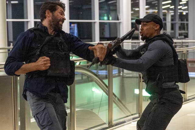 <p>Air rage: Scott Adkins (left), the star of ‘One More Shot’, filming at Stansted airport</p>