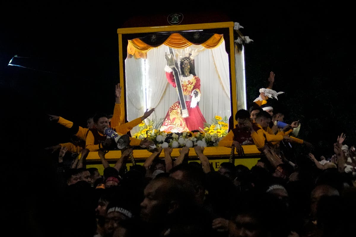 Filipino Catholics pray for Mideast peace in massive procession venerating a black statue of Jesus