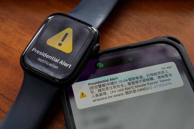 <p>A phone and watch that received an air raid alert is placed together for a photo in New Taipei City, Taiwan</p>
