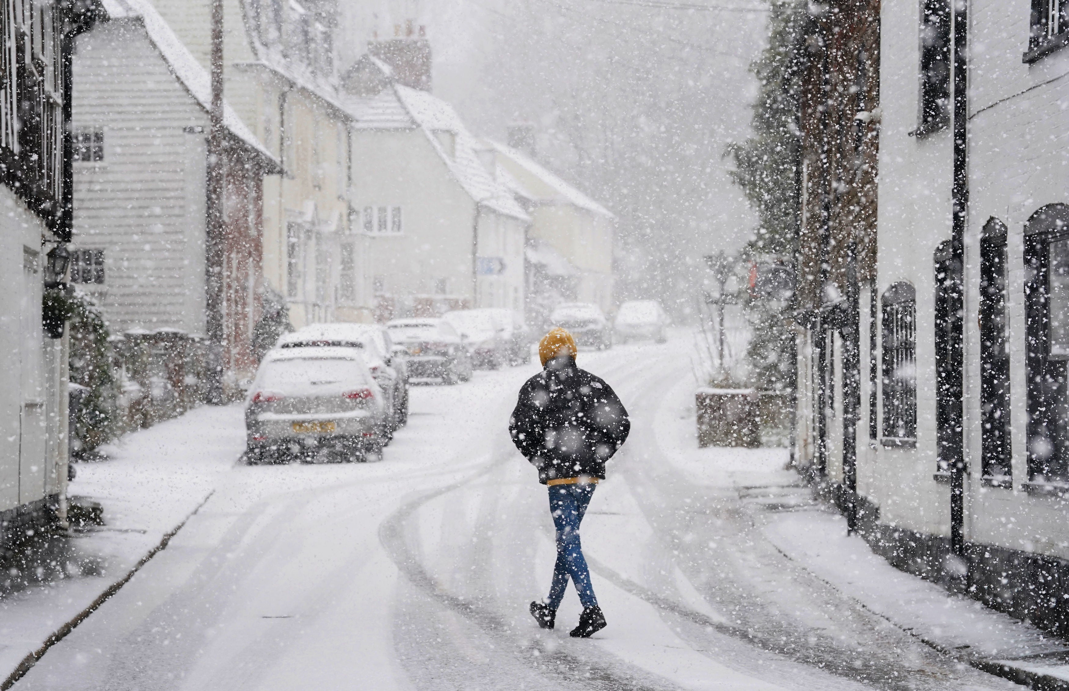 A person walking through a snow flurry in Lenham, Kent. Sleet and snow showers battered the UK on Monday