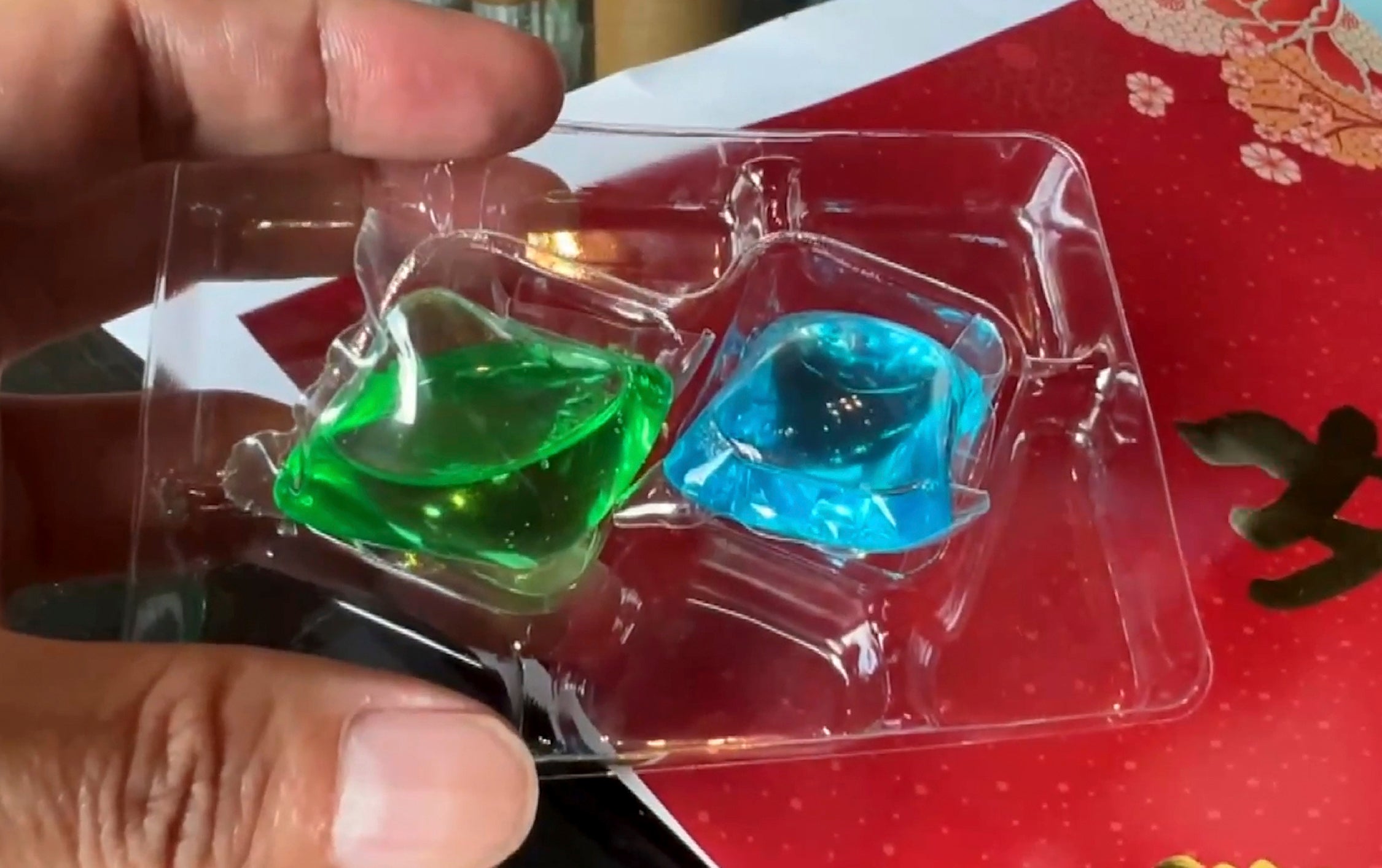 This image taken from video shows liquid laundry detergent balls inside a package given by Nationalist Party (KMT)