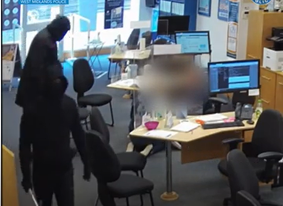 Staff members being forced onto the floor after the armed robbers burst into an estate agents