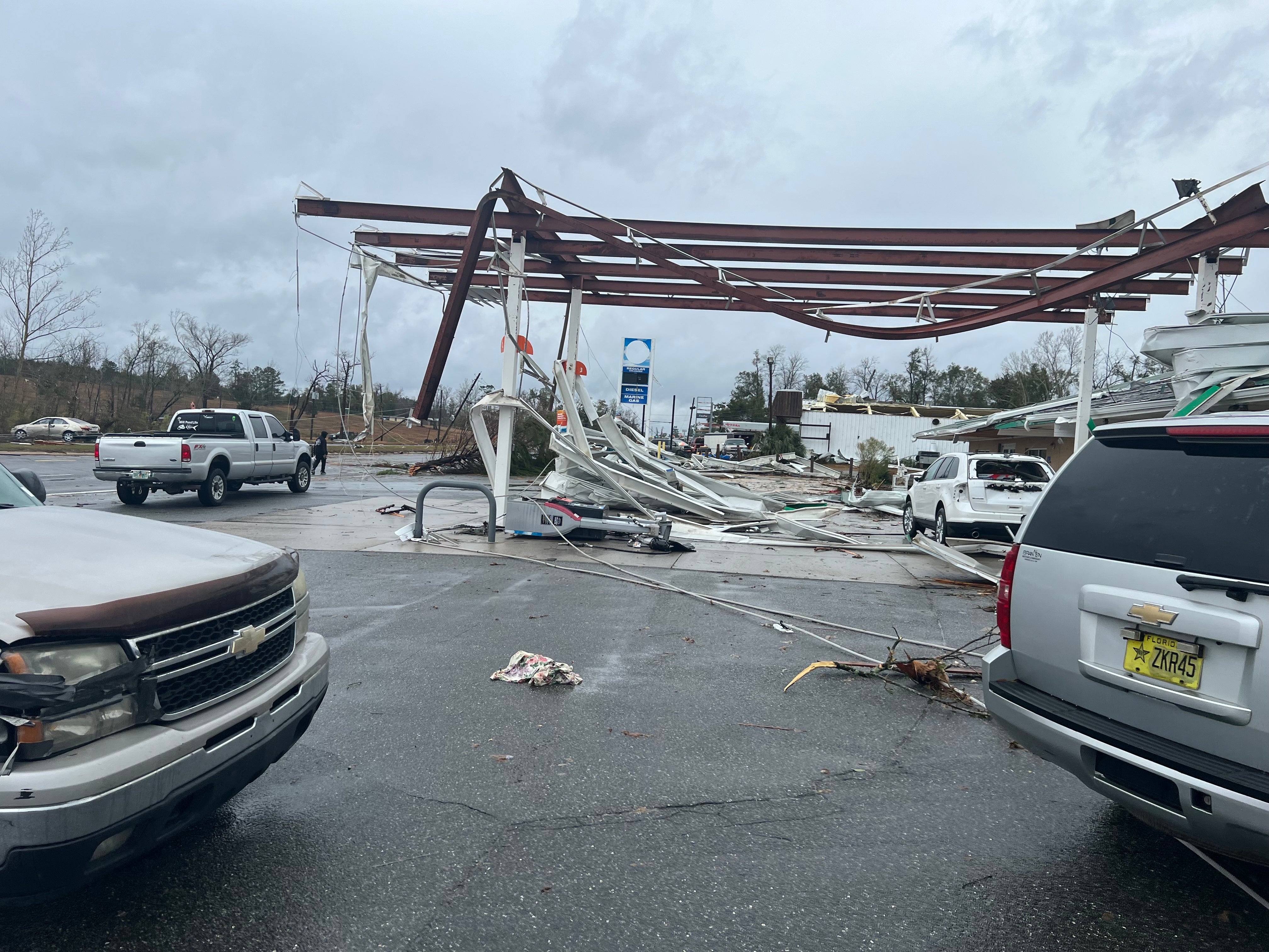 A damaged gas station and debris pictured in Jackson County, Florida on 9 January following a tornado