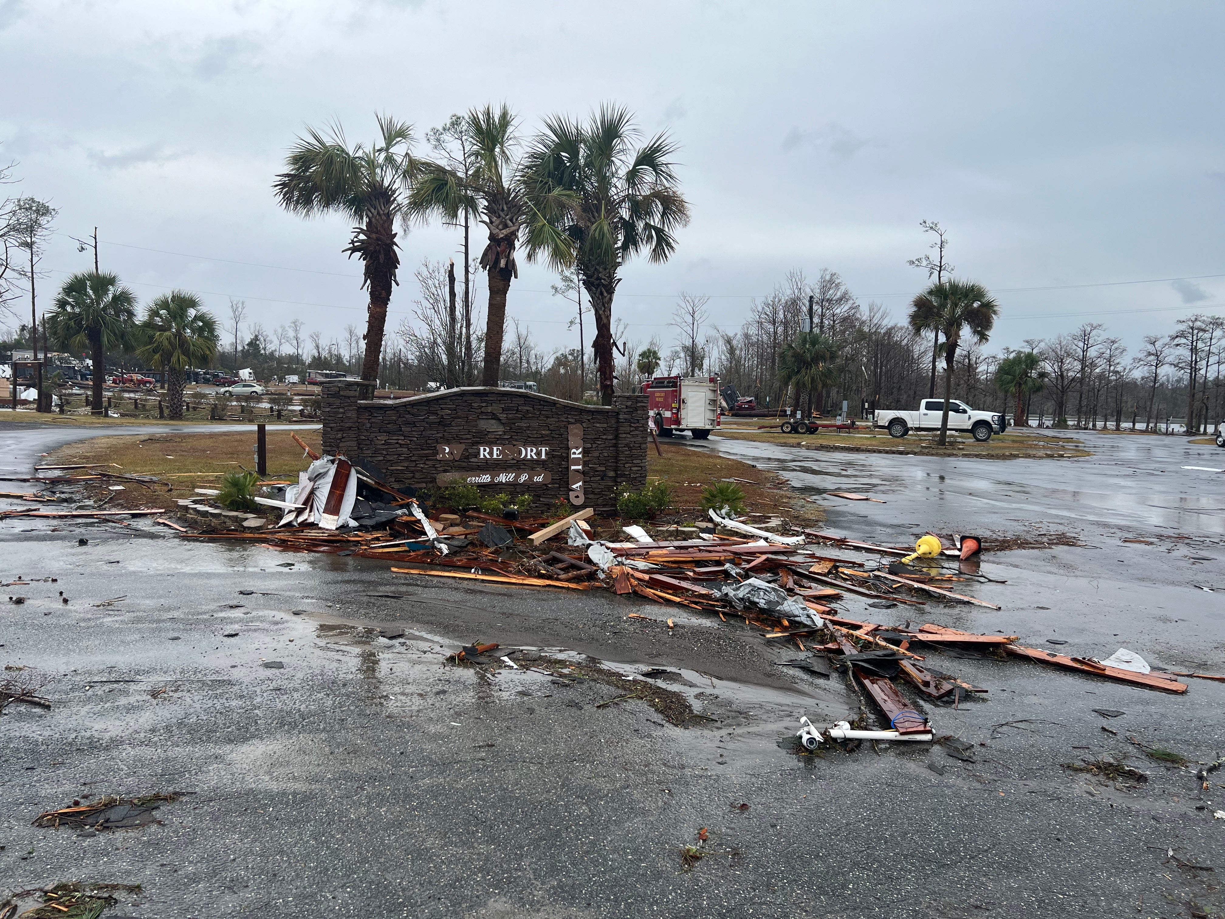A damaged sign in a parking lot and debris pictured in Jackson County, Florida on 9 January following a tornado
