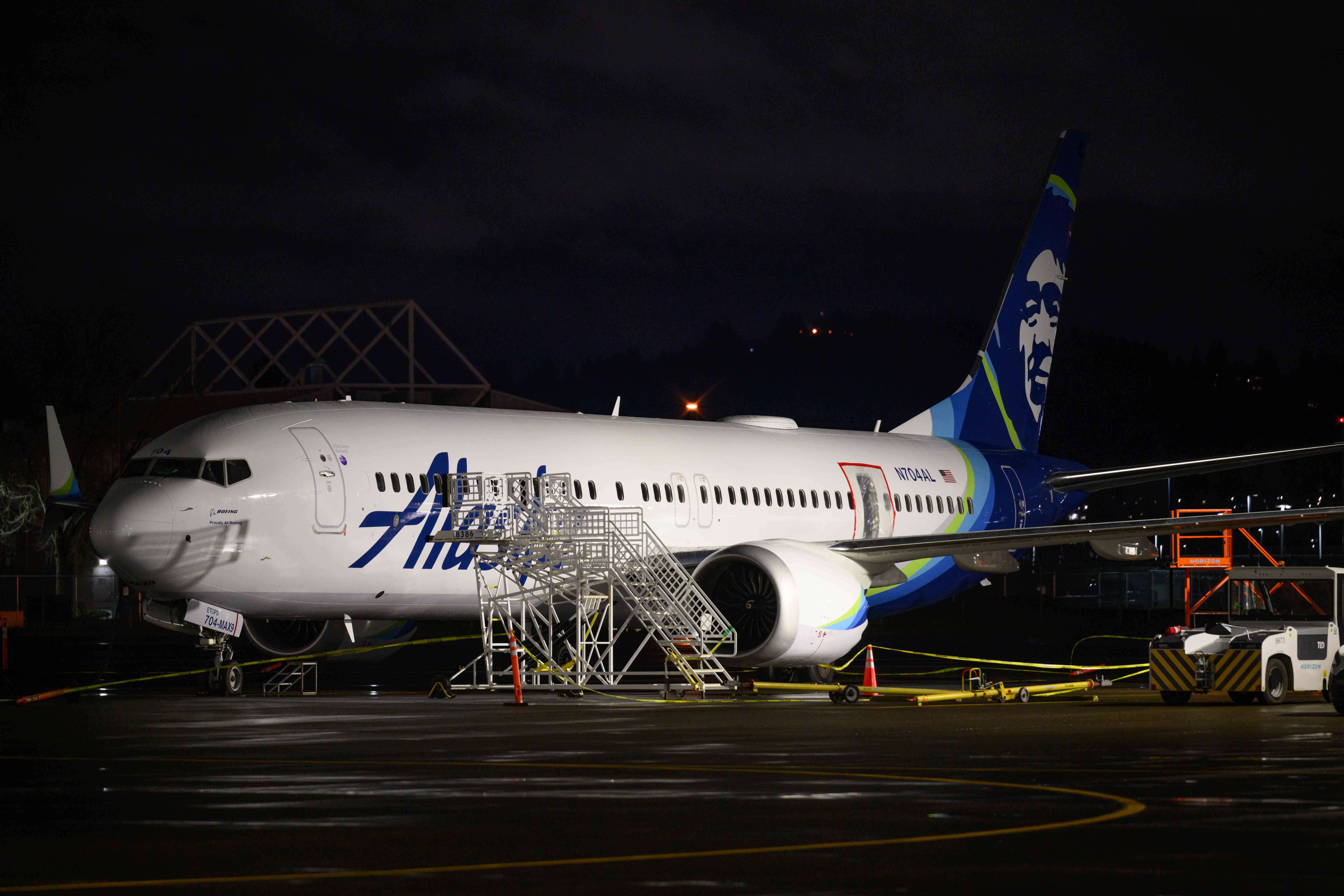 A plastic sheet covers an area of the fuselage of the Alaska Airlines N704AL Boeing 737 MAX 9 aircraft outside a hangar at Portland International Airport on 8 January 2024 in Portland, Oregon.