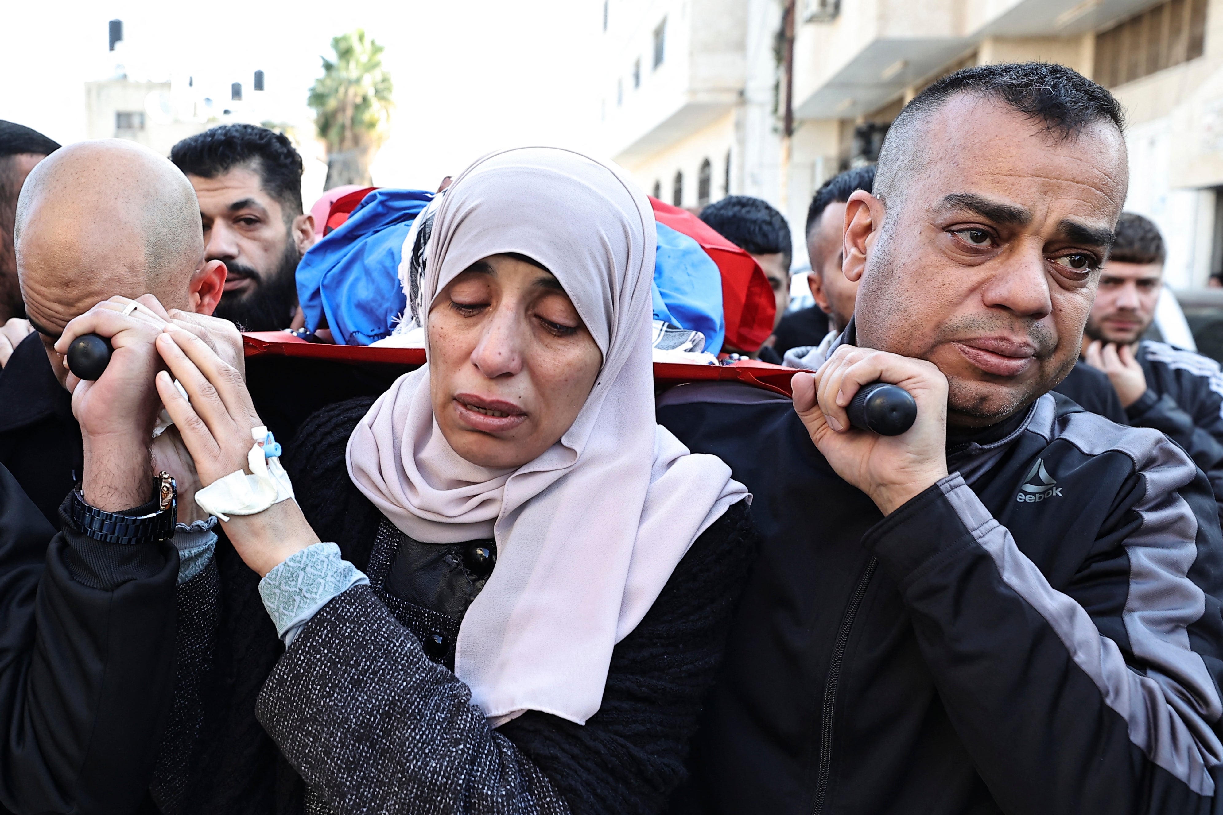 Relatives of a man killed in the occupied West Bank on Tuesday prepare for his burial