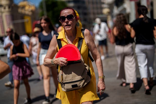 <p>A woman fans herself in Madrid, Spain during heatwave in July 2023. Europe is the fastest heating continent  </p>