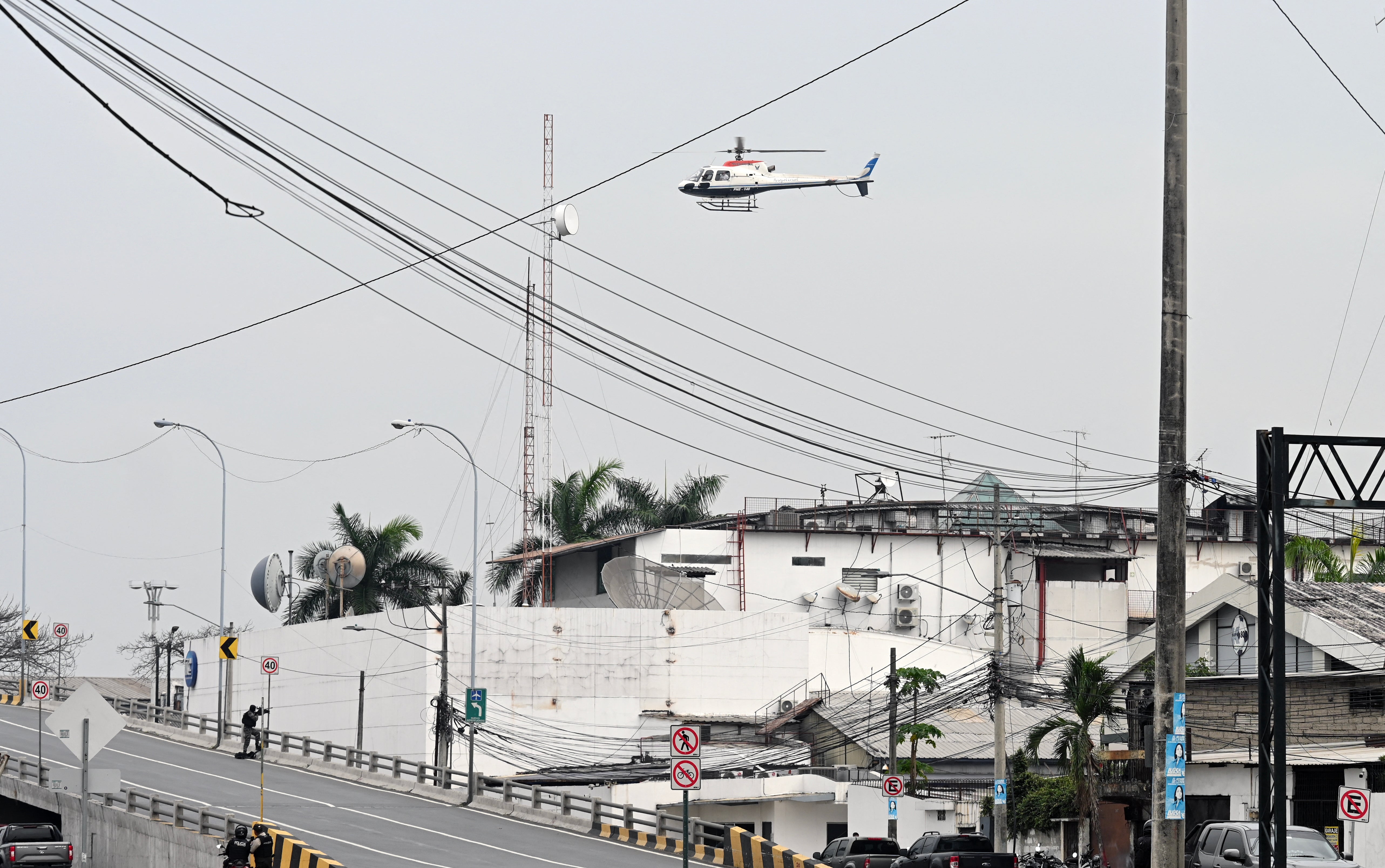 An Ecuadorean police helicopter flies over the TC television studio