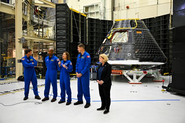 <p>The crew of Artemis II, US astronauts Victor Glover (R), pilot; Reid Wiseman (2nd L), commander; Christina Hammock Koch (2nd R), mission specialist; and Canadian astronaut Jeremy Hansen (R), mission specialist, stand with NASA Deputy Administrator, Pamela Melroythe (R), and the Artemis II crew module (rear) inside the Neil Armstrong Operations and Checkout Building at the Kennedy Space Center in Cape Canaveral, Florida, on August 8, 2023</p>