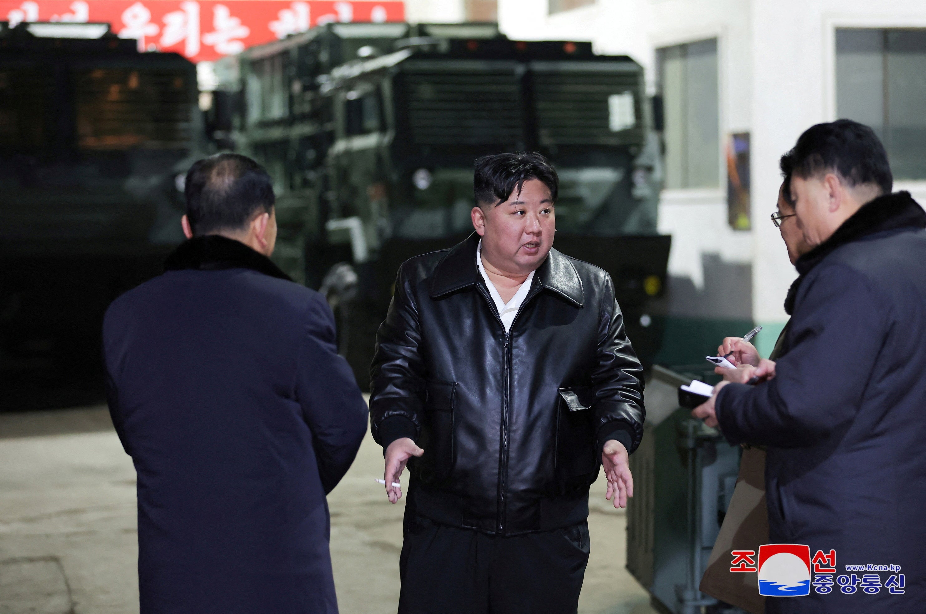 North Korean leader Kim Jong Un speaks to officials at a munitions factory