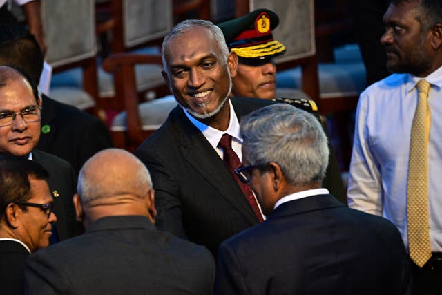 <p>File Maldives’ president Mohamed Muizzu (C) leaves his inauguration ceremony in Male on November</p>