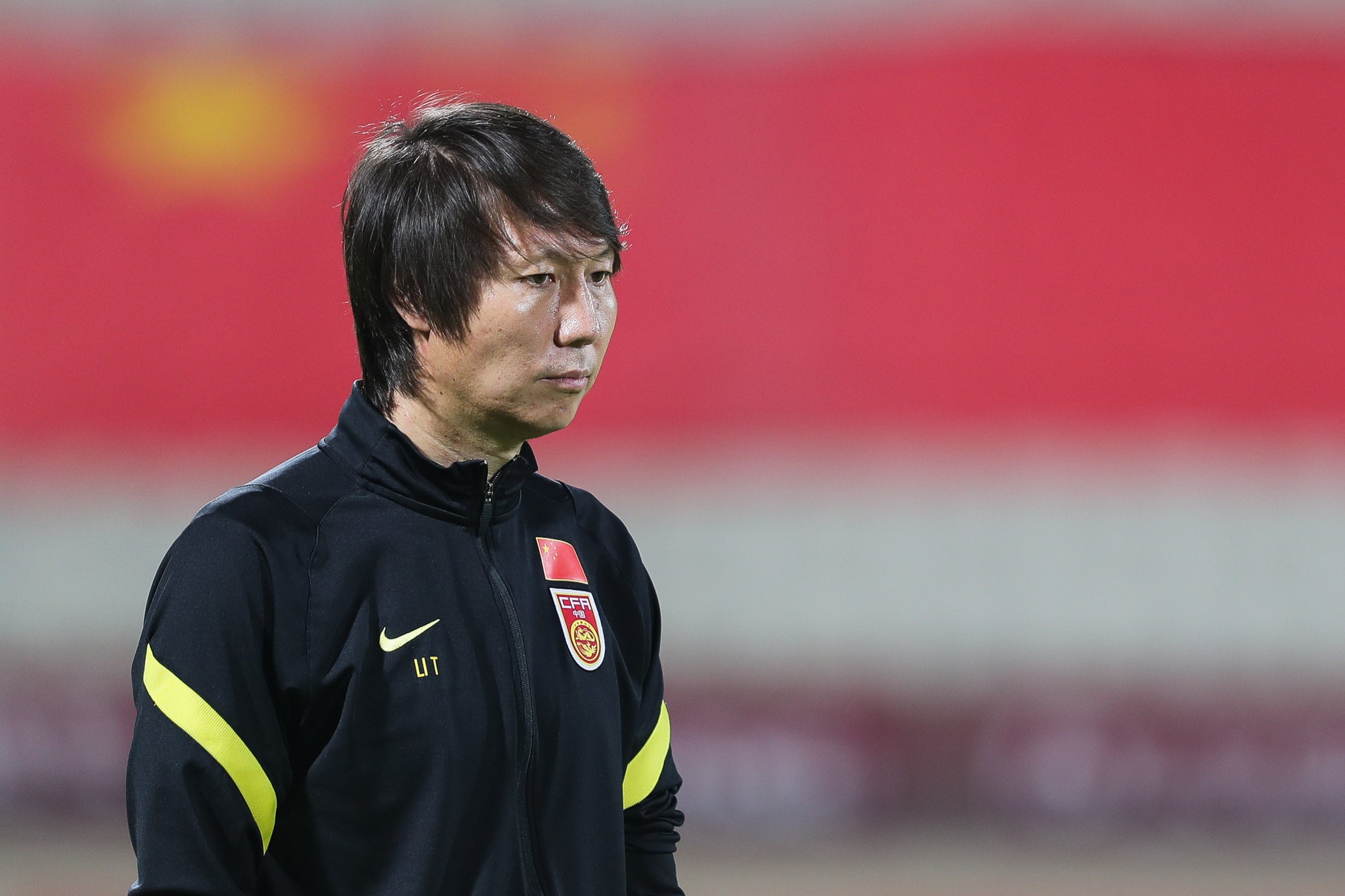 Li Tie, the head coach of the China national football team, watches the pre match warm up during the 2022 FIFA World Cup Asian Qualifiers