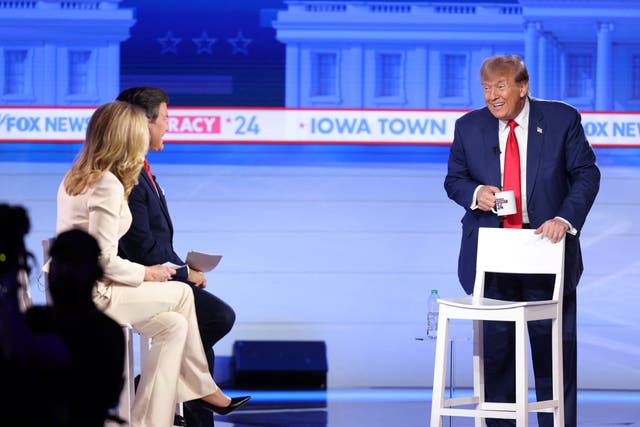 <p>Republican presidential candidate and former U.S. President Donald Trump talks to the hosts during a commercial break at Fox News Channel town hall ahead of the caucus vote in Des Moines, Iowa, U.S., January 10, 2024</p>