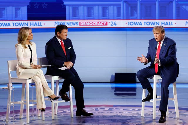 <p>Former US President and 2024 Republican presidential hopeful Donald Trump speaks as moderators Bret Baier and Martha MacCallum look on during a town hall in Des Moines, Iowa</p>