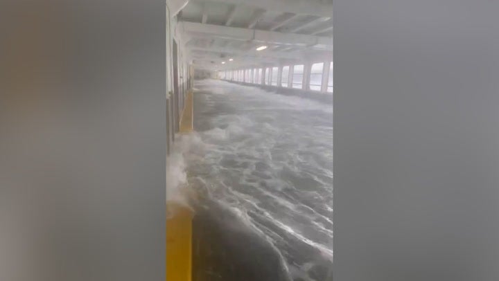 <p>Huge waves flood ferry deck and smash against cars during Washington storm.</p>