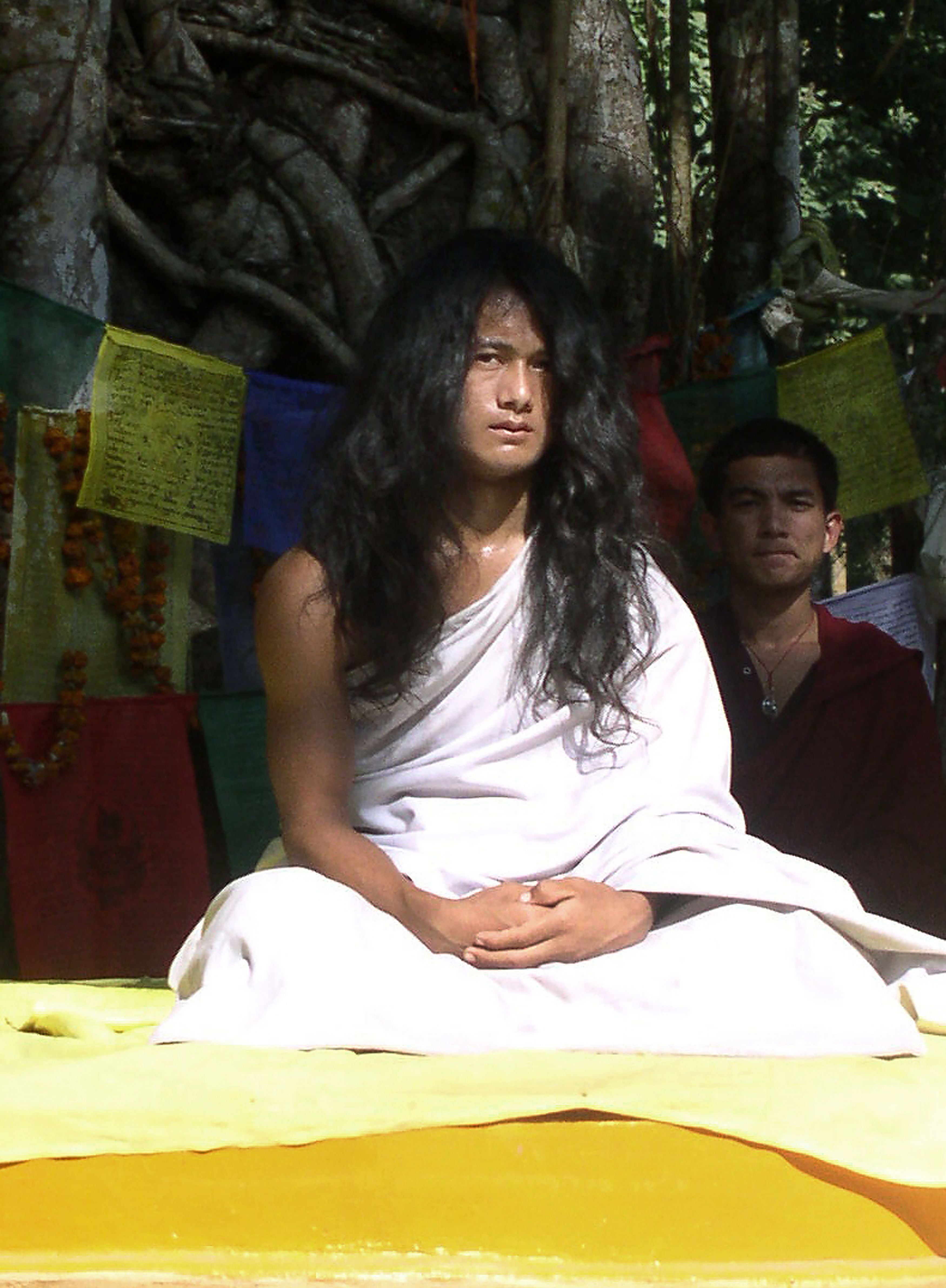 Nepali spiritual leader Ram Bahadur Bomjan, dubbed “Buddha Boy”, sits under a tree before an audience gathered to listen to his sermon in Ratanpuri