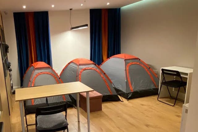 <p>Three tents visible in the living room photos on the Airbnb listing </p>