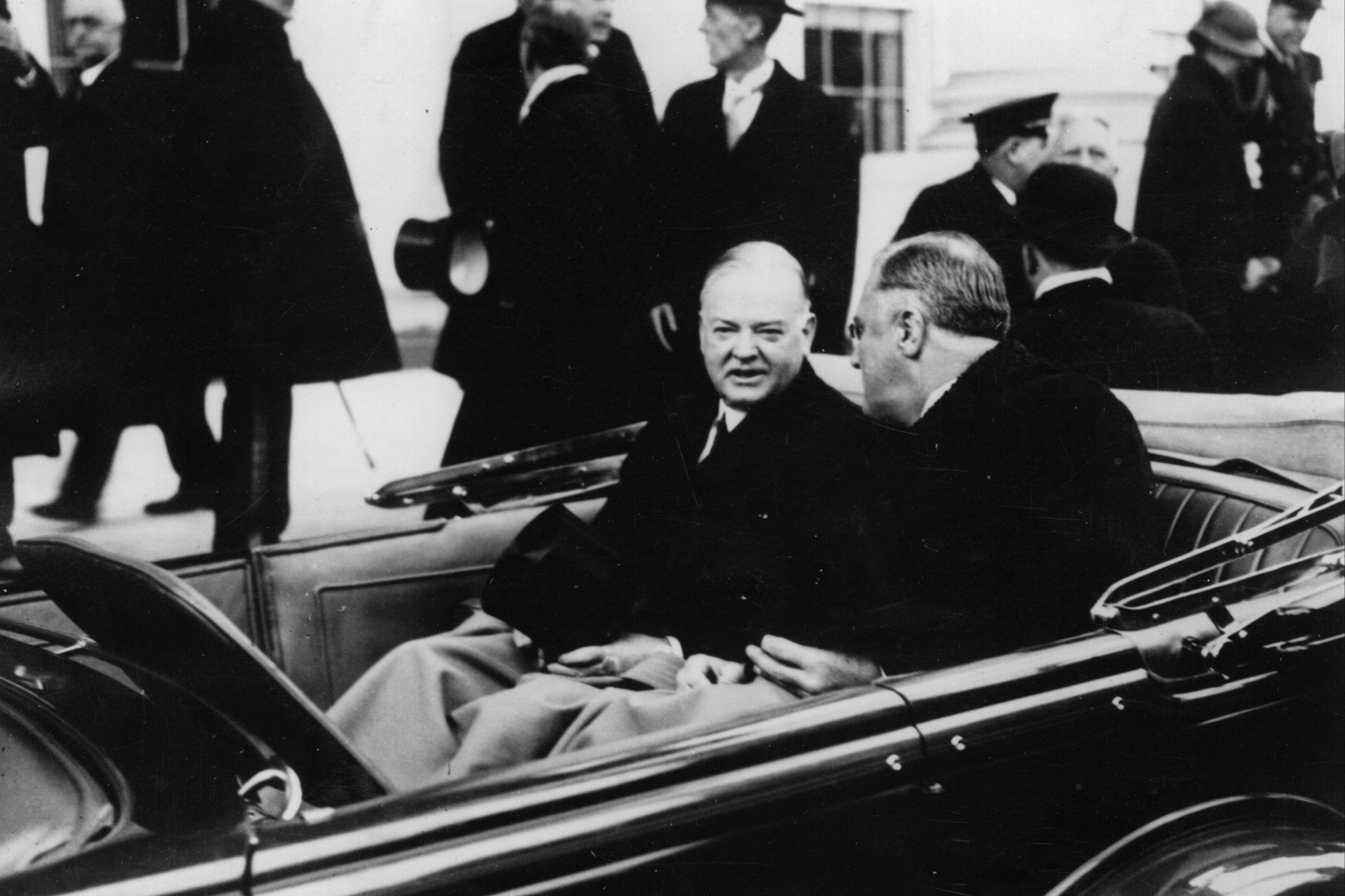 Herbert Hoover, left, with Franklin D Roosevelt on the way to the latter’s swearing-in ceremony on 16 March 1933