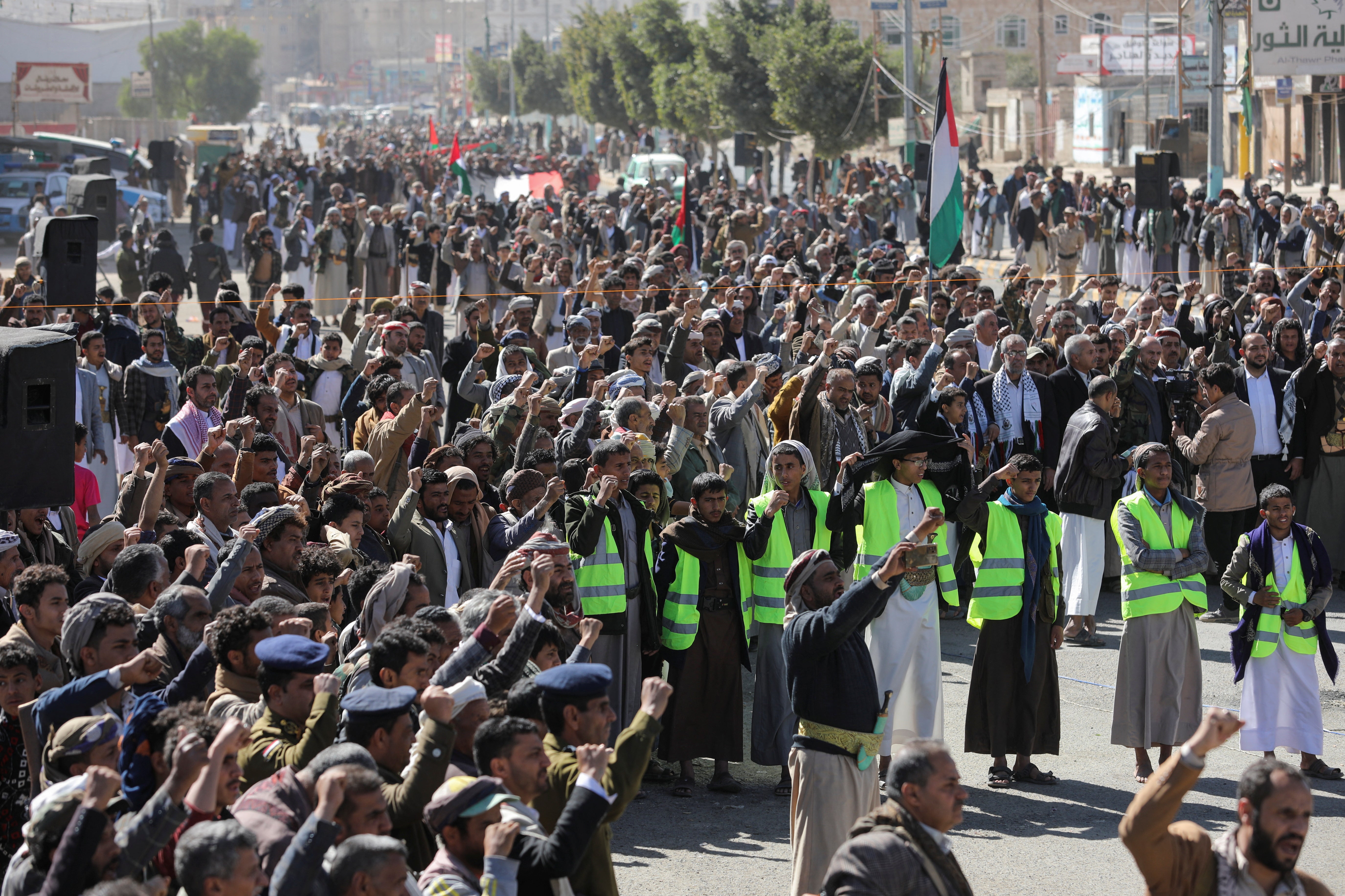 Houthi supporters shout slogans as they attend a ceremony at the end of the training of newly recruited fighters in Sanaa