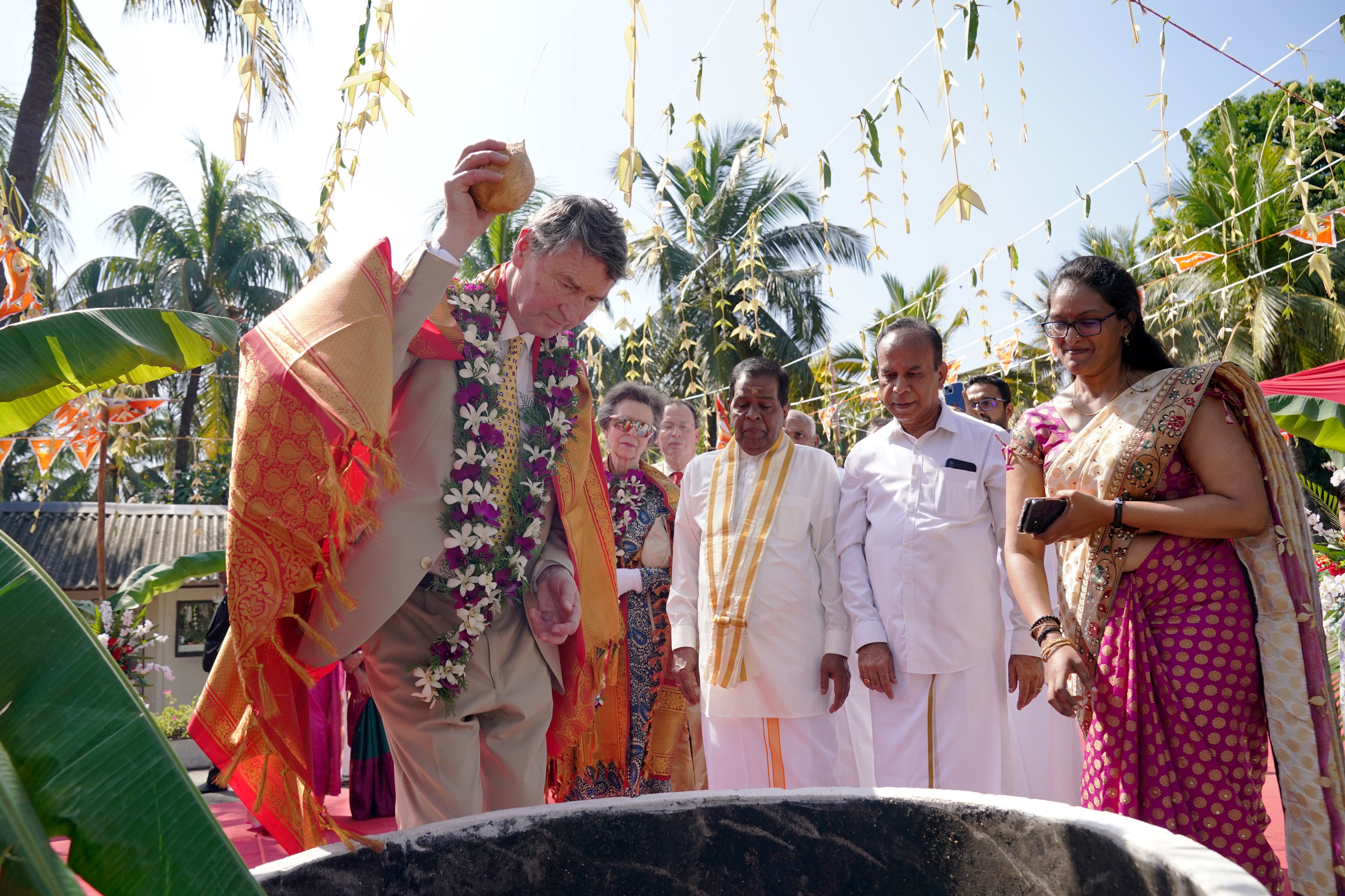 Vice Admiral Sir Timothy Laurence smashed a coconut in a ritual believed to banish bad luck (Jonathan Brady/PA)